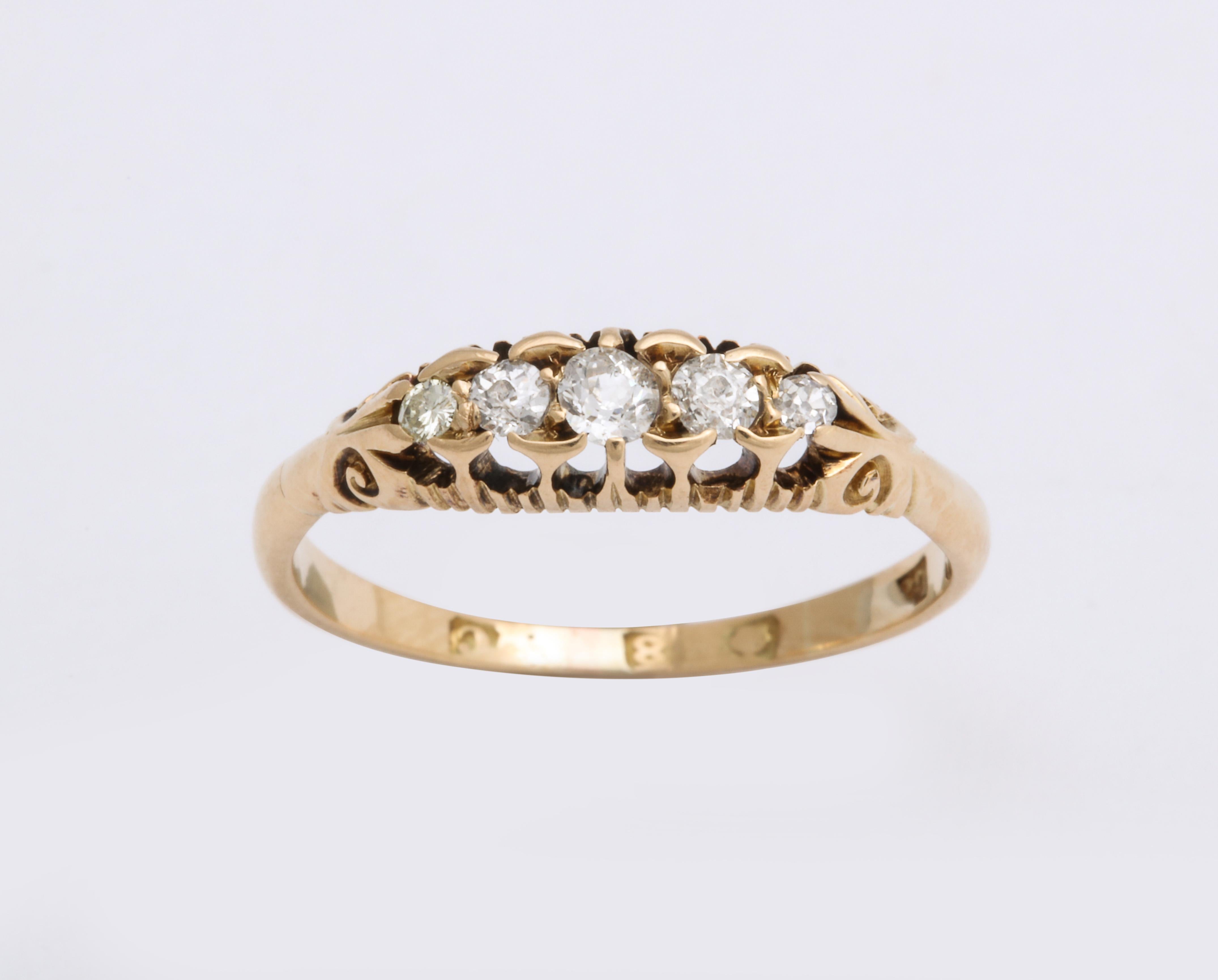 Beautiful English 18k gold ring, the half hoop set with five graduated antique-cut diamonds, in an 18k gold mount. 

English, hallmarked (rubbed), stamped 18 with date letter for London 1958.  

Size 8. Length of diamond band: 1/2 in. (1.3 cm);