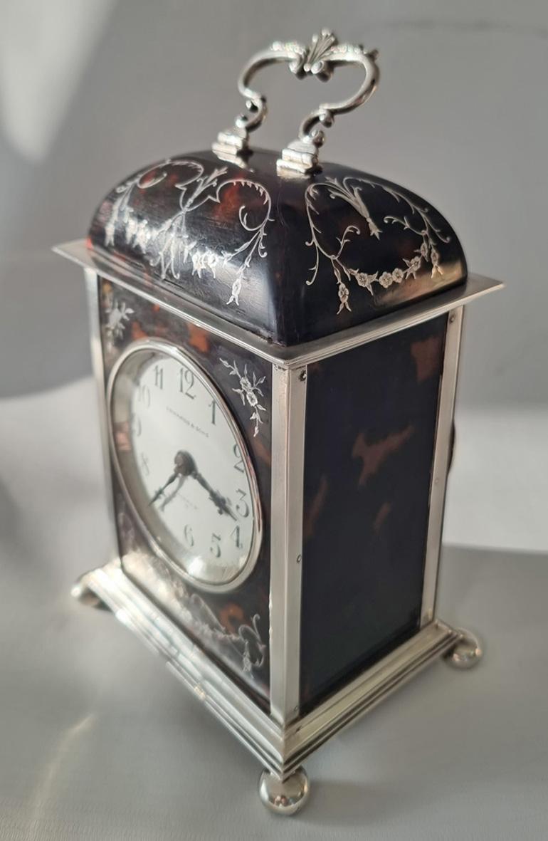 A very attractive English Edwardian dome topped tortoiseshell, silver & silver piquet carriage clock. 
Tortoiseshell panels to the sides & solid silver back door.
The dome top and the tortoiseshell front plate profusely decorated with delicate
