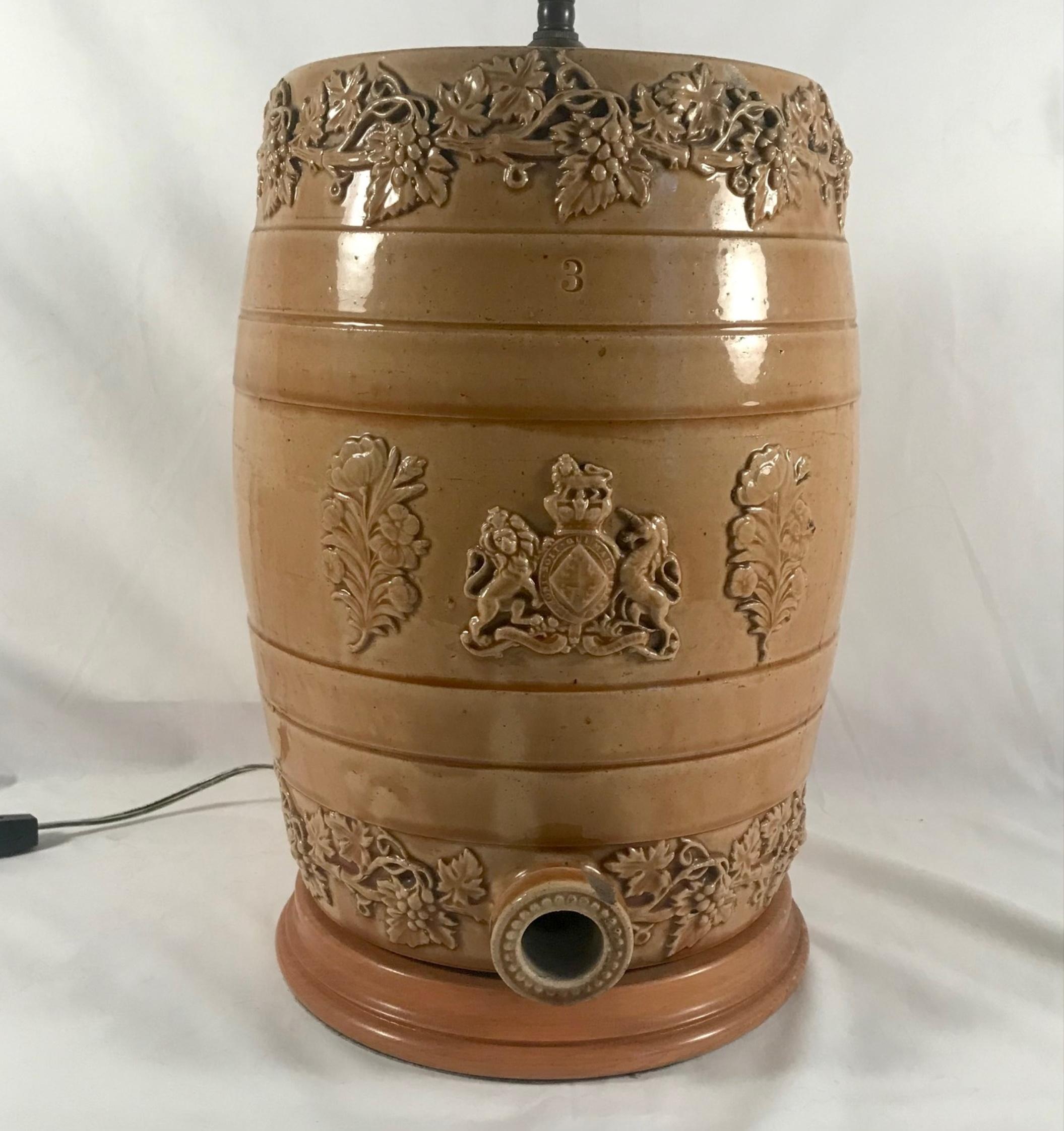 Antique English Doulton Lambeth style salt glaze whiskey barrel - Water cooler by Powell, Bristol

Antique Victorian salt glazed stoneware whiskey barrel adapted into a lamp. The golden brown colored water cooler is beautifully decorated with hand