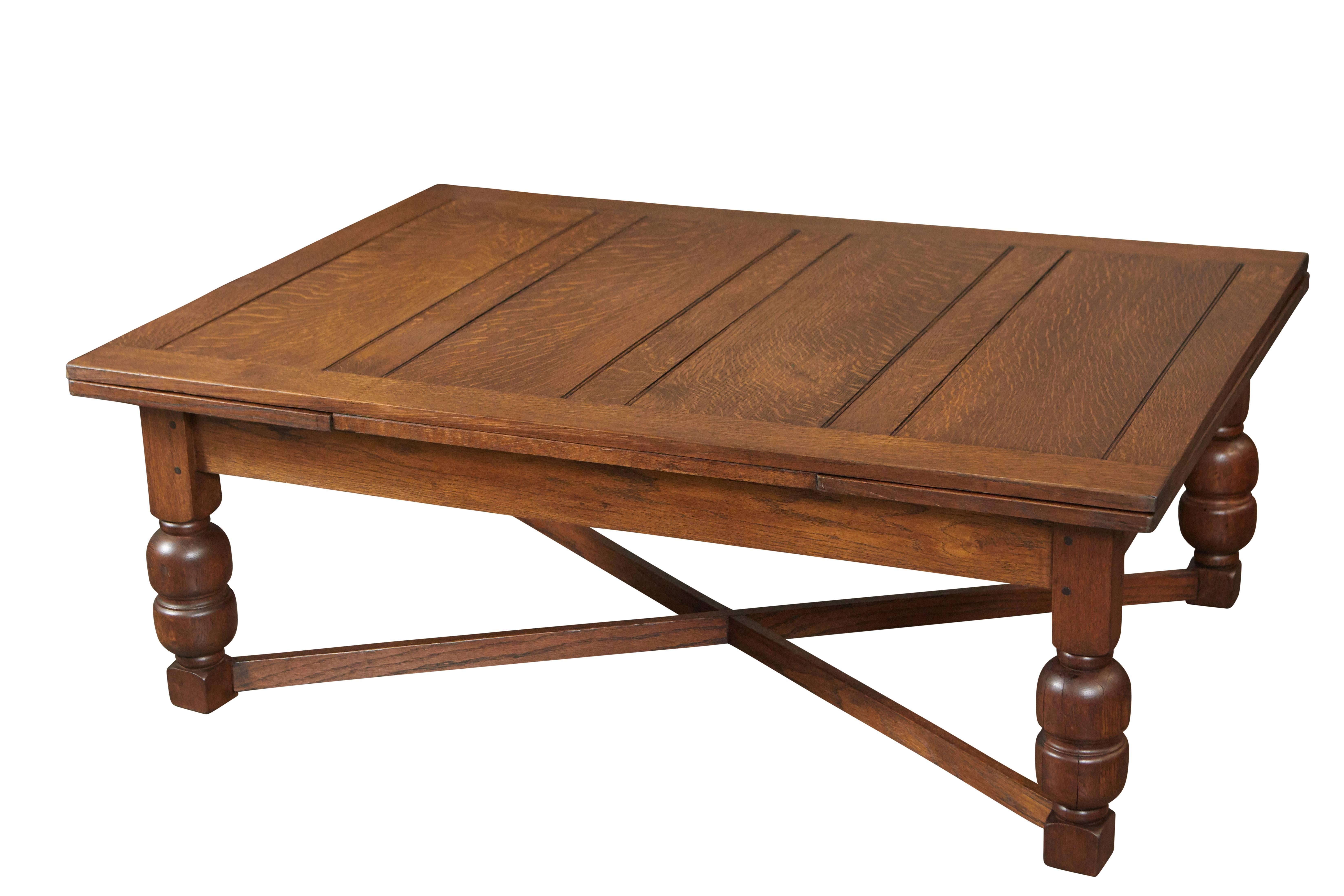 This large oak draw leaf table started life as a dining table, then at some point was made into a coffee table. The draw leaves gives it the versatility to suit a variety of uses and settings. 

Measure: 19.25