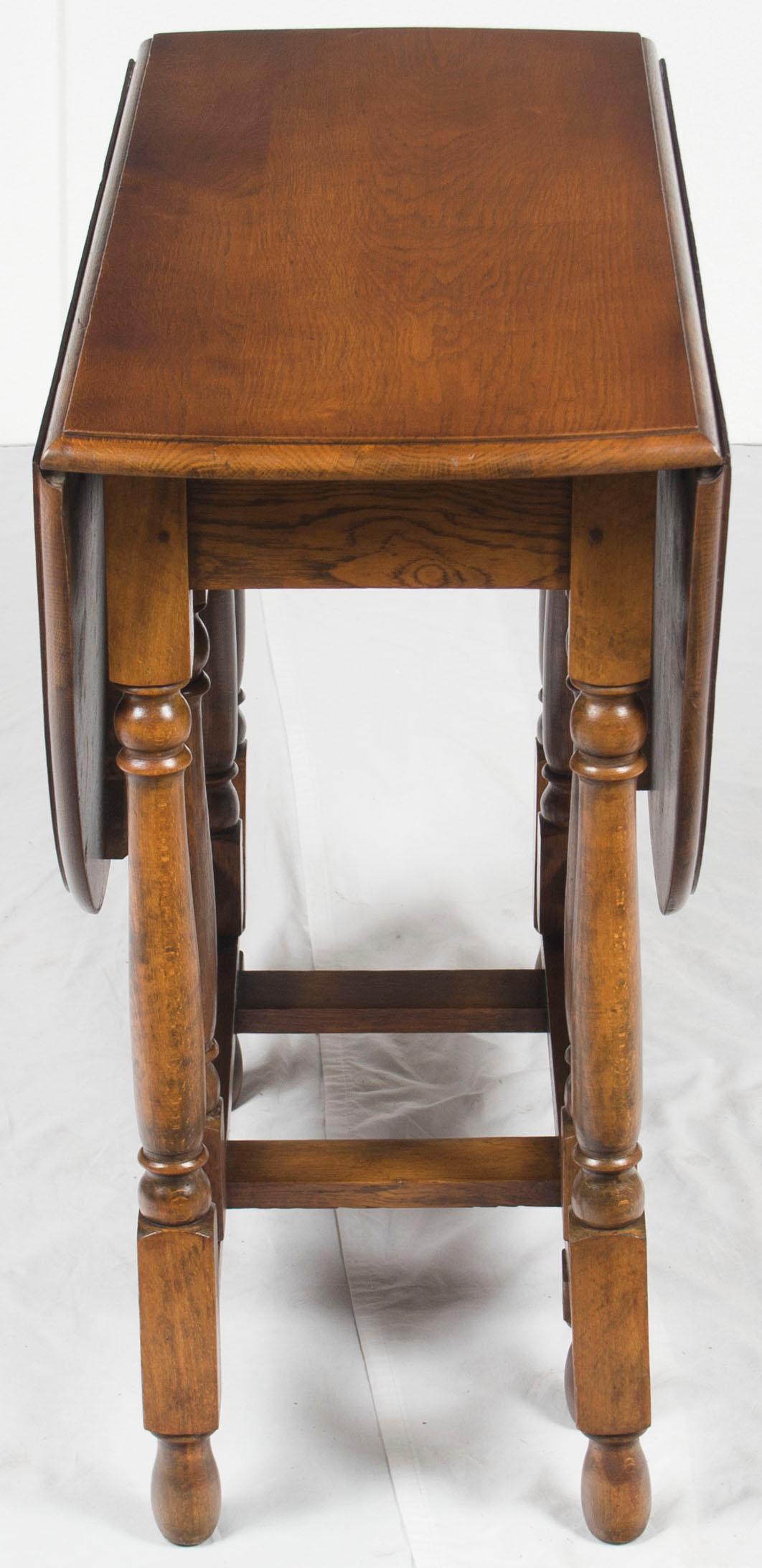 Beautiful side tables like this antique gate leg are a must for any home. Their decorating diversity allows you to use them in any number of places in any room.

This particular antique gate leg is oak and was made in England around 1920. The oak