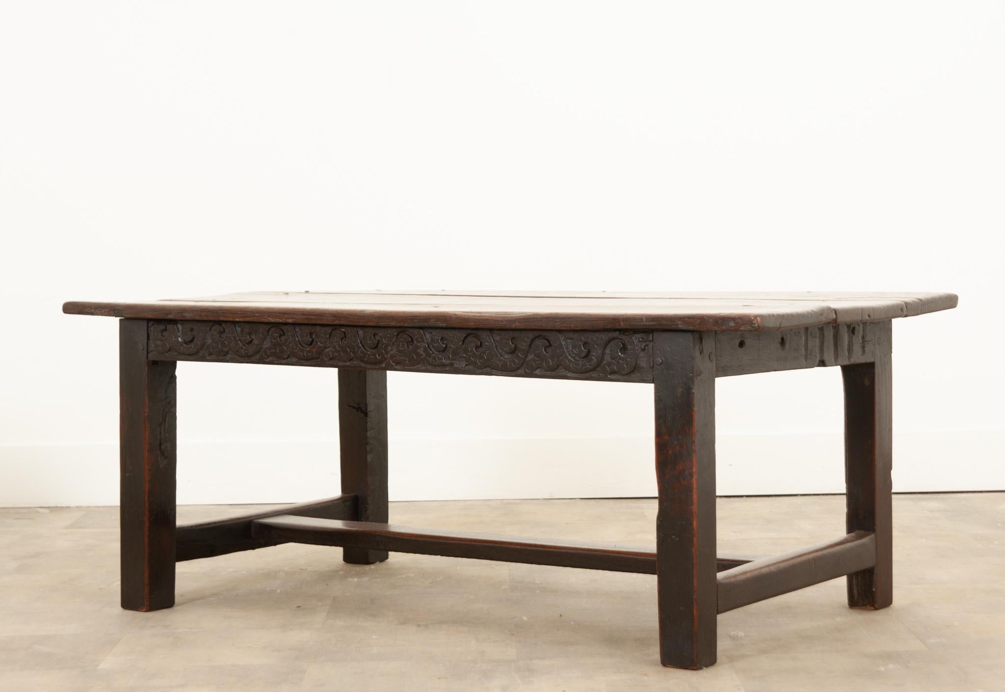 A fantastic piece hand-crafted in England over 300 years ago. A superbly carved oak low table supported by straight square legs attached by a classic H-stretcher that creates an attractive sturdy piece. The construction of the table is solid oak put