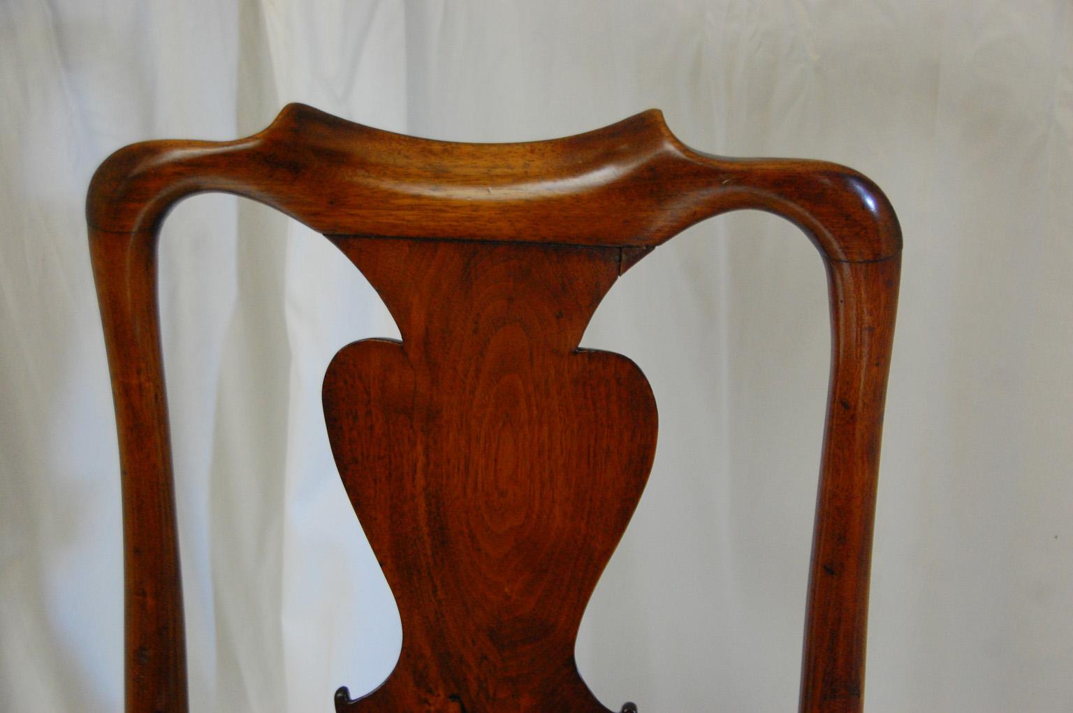 English Queen Anne walnut side chair with cabriole legs, pad front feet, turned stretcher connecting back legs, and slip seat. This elegant chair has a graceful curved tall back with handsome central solid walnut shaped splat. The timber was