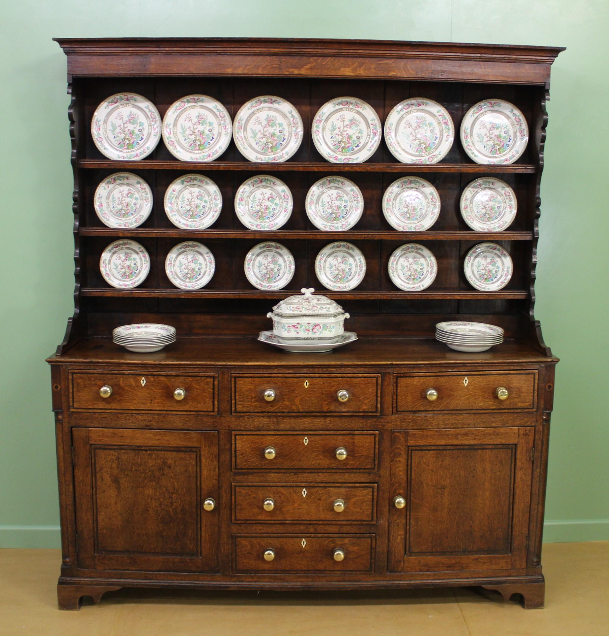 A charming early 19th century English oak dresser. Well constructed in solid oak and with pine drawer linings and back boards. In very good original condition with a great mellow color and patina. The base section with a series of drawers and