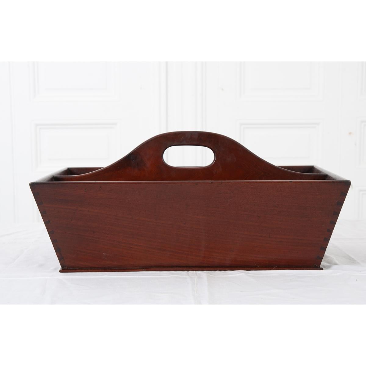 A handsome means of carrying your supplies, this outstanding mahogany tray was made in England, circa 1820. Note the antique’s stylish design and near-perfectly executed dove-tailed corners! A hole found in the center divider provides a handle to