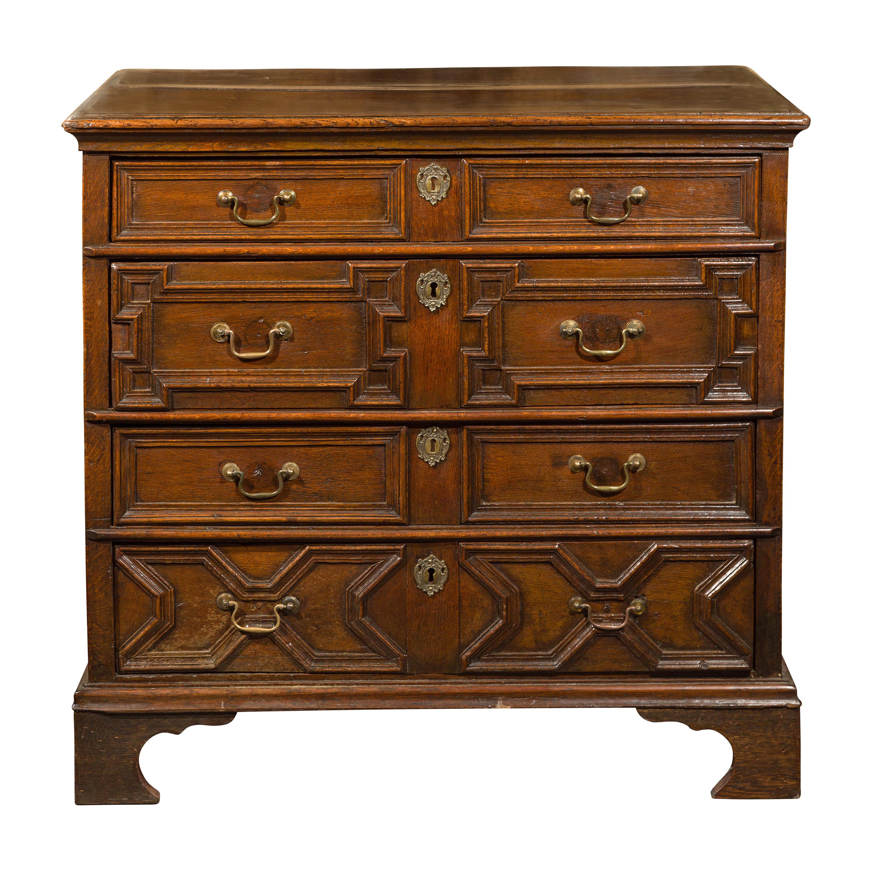 English Early 19th Century Oak Geometric Front Four-Drawer Chest on Bracket Feet For Sale