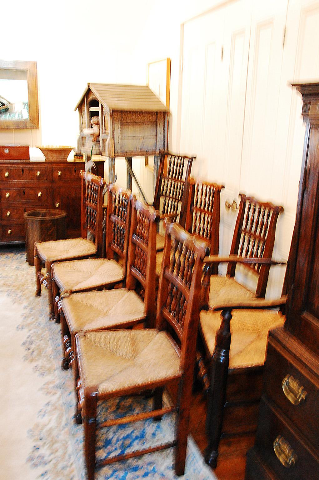 English early 19th century assembled set of eight spindleback dining chairs including two armchairs and six sidechairs. These chairs were made in the Lancashire/Cheshire region of England and typically were purchased over a period of time, rather