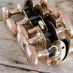 English Early 20th Century Rose Brass Oval Door Knobs