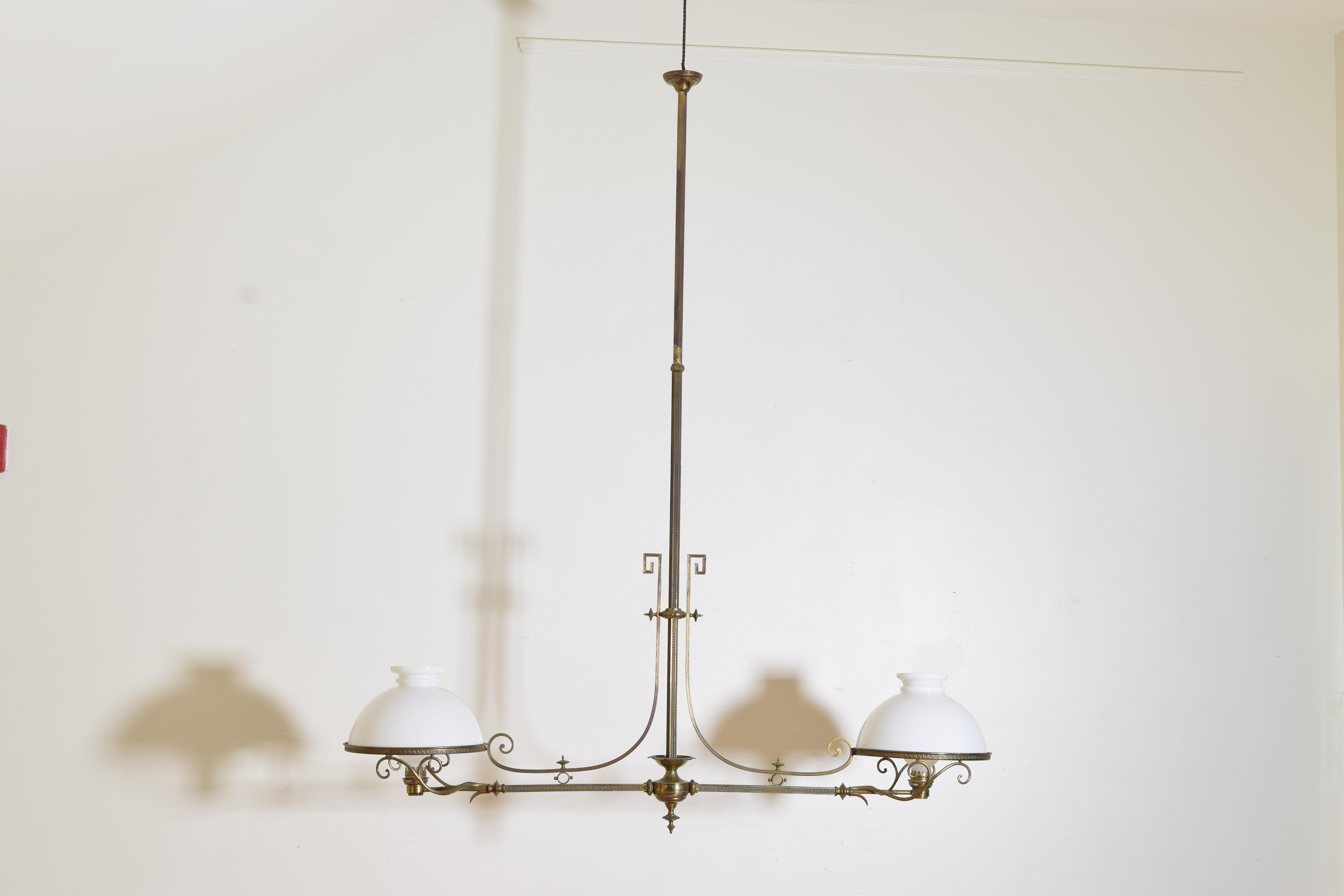 Formerly an oil burning lamp this billiards fixture is suspended from a long hexagonal down rod incised with Greek key decoration the down rod issuing two shaped arms ending in original white glass shades surrounding frosted glass inner chimney