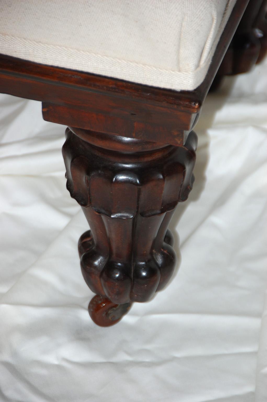 English carved rosewood ottoman by Lamb of Manchester. This large stool was made by Lamb of Manchester and has his name impressed into the frame (Lamb Manchester). Lamb was an internationally acclaimed maker of fine furniture; he employed some of