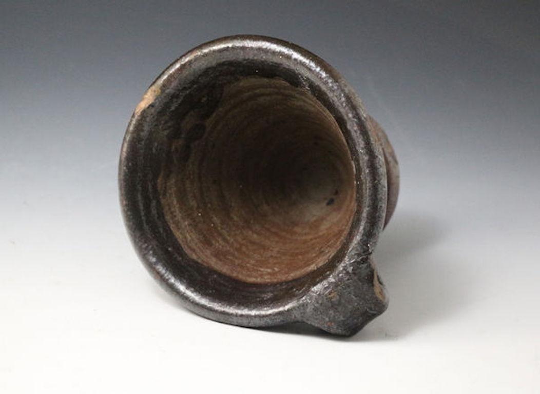 A rare and unrecorded earthenware mortar and handle with a pinched terminal. The pestle would probably have been made of hardwood. Very few of these pieces have survived, this example is very robustly and heavily potted and is in fine condition with