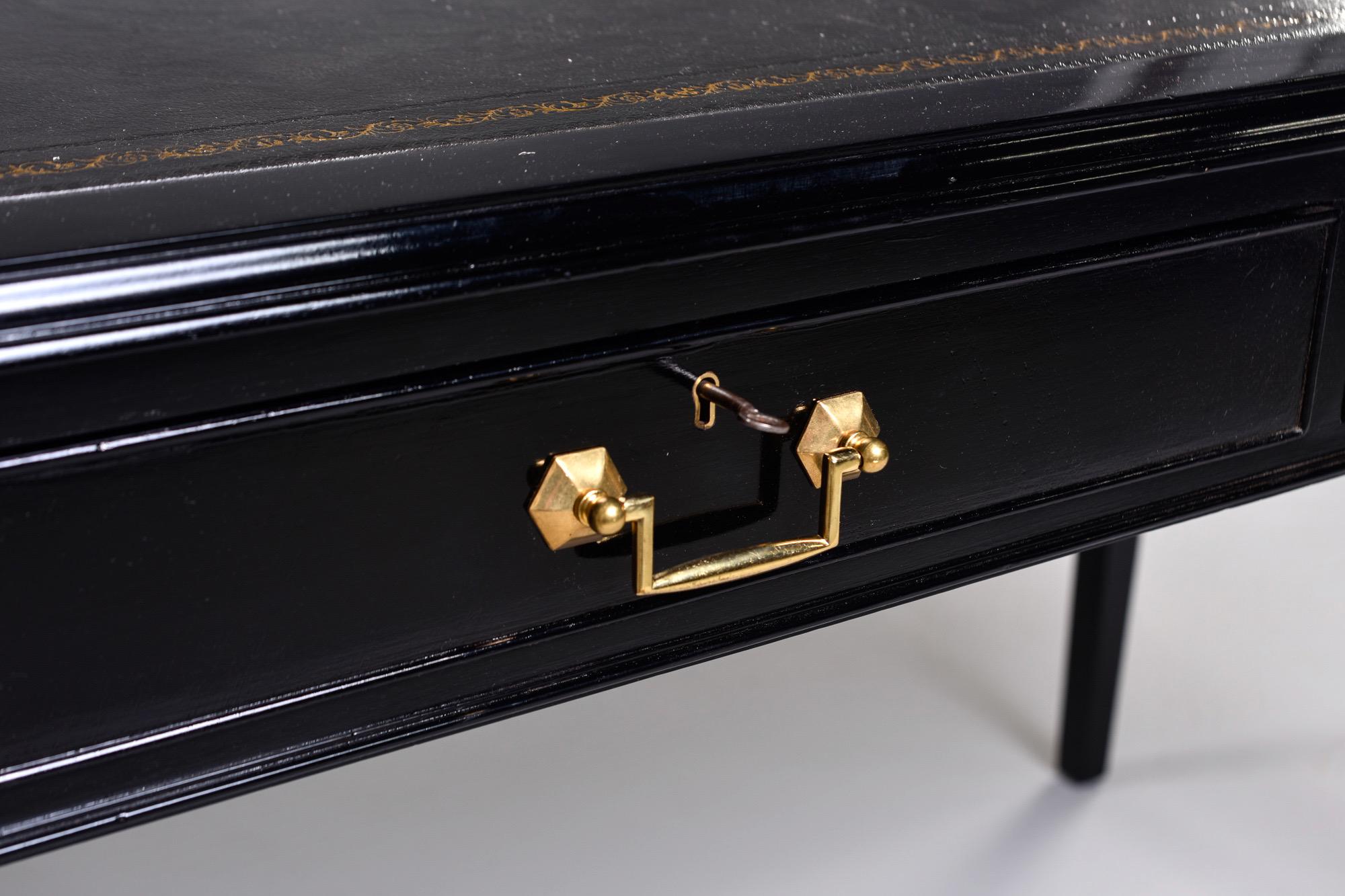 Circa 1900s English mahogany partners desk with new ebonised finish and new black leather top. Two narrow locking drawers with brass hardware. Unknown maker.

Has one key.