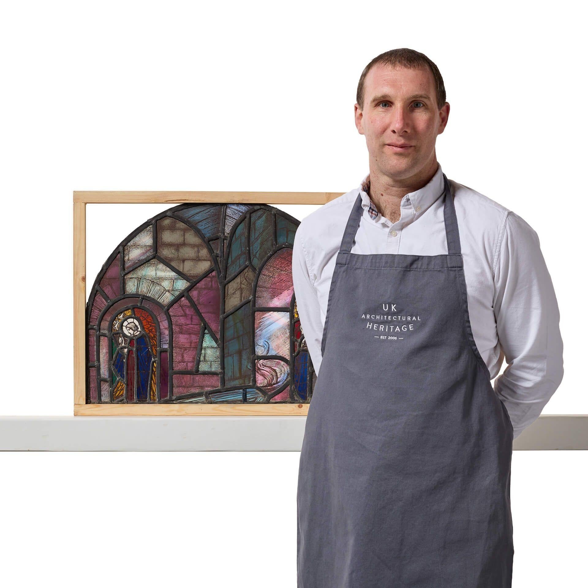 An early 20th century English ecclesiastical arched stained glass window, circa 1925. At first glance, this reclaimed window appears to simply be a colourful abstract piece; but look closer and you’ll discover a church or cathedral scene. Observe a