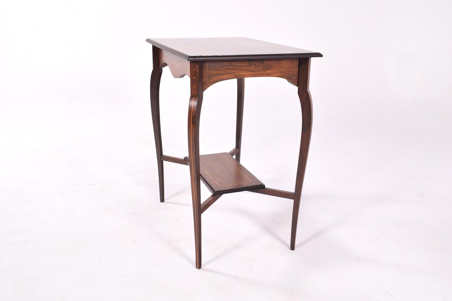 This fine decorative inlaid rosewood Edwardian, antique side table or occasional table, dates from circa 1900. It has a rectangular top and stands on four tapering legs with a lower inlaid.