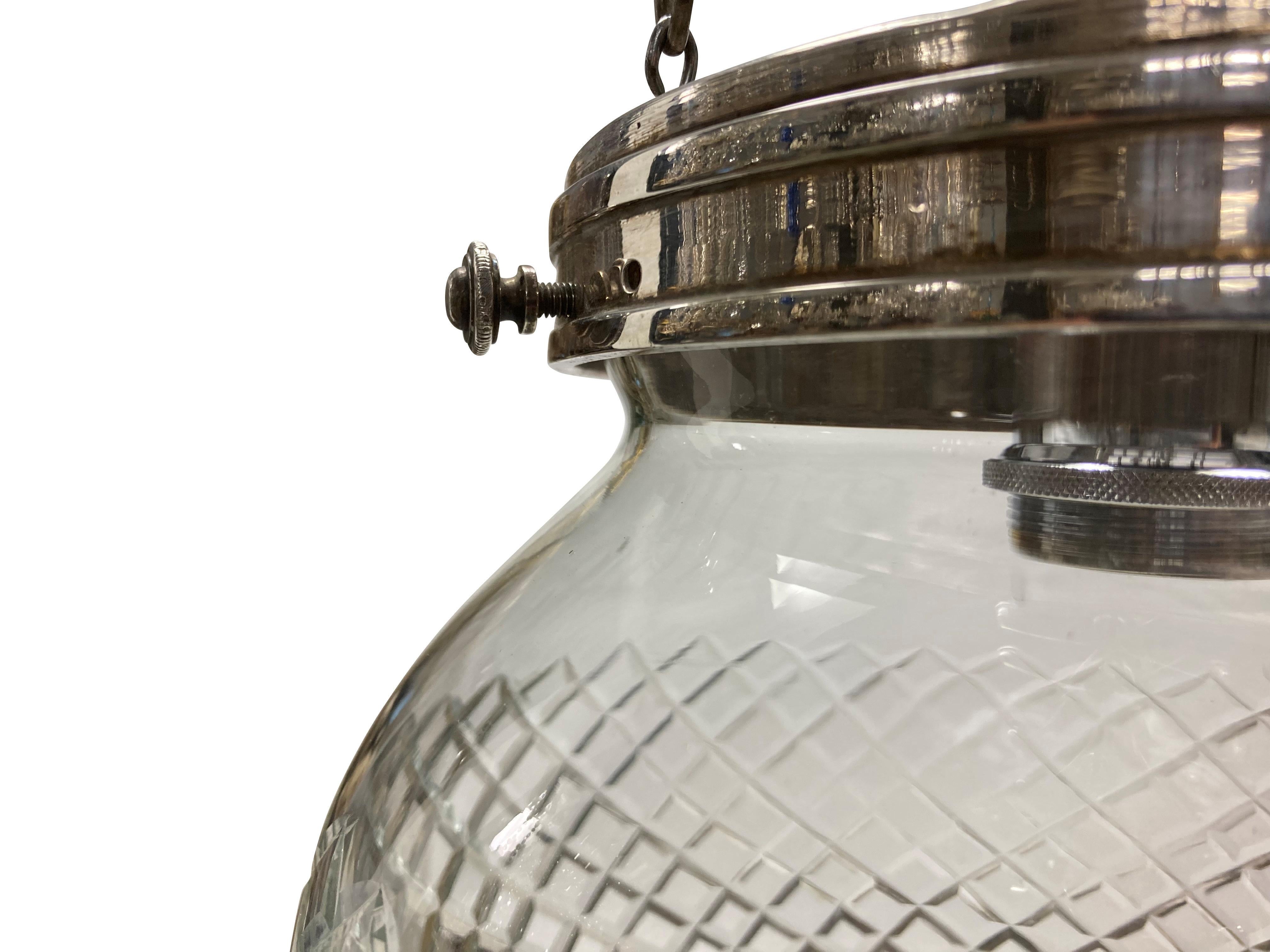 An English Edwardian silver plated bronze and glass pendant light.