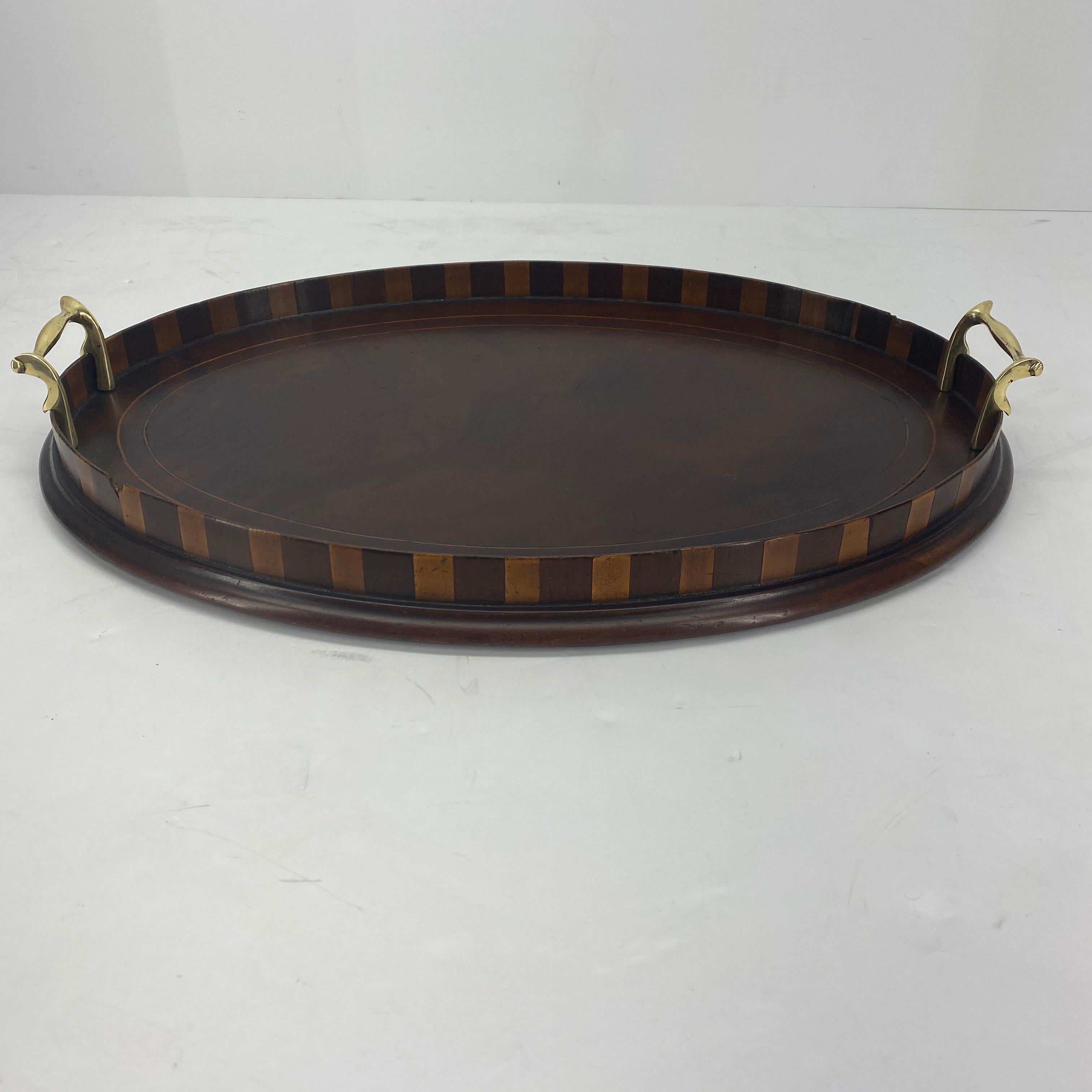 Small oval Edwardian mahogany and citrus inlaid bar tray with original brass handles.

    