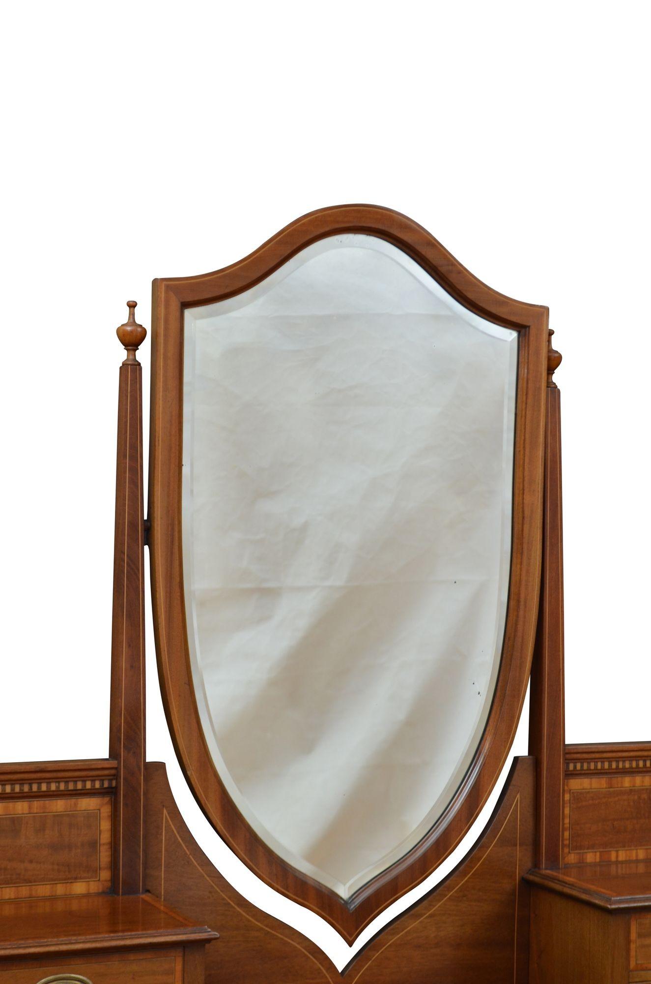 P0304 Stylish Edwardian dressing table, having original bevelled edge mirror with minor foxing in string inlaid shield shaped frame in inlaid uprights with decorative vases terminating in four mahogany lined and crossbanded jewellery drawers fitted
