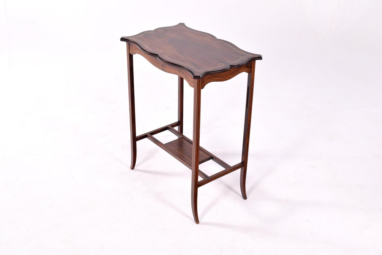 Antique side table, an English, Edwardian lamp table in rosewood. Elegant lines and the top bordered by a tramline boxwood string perimeter.