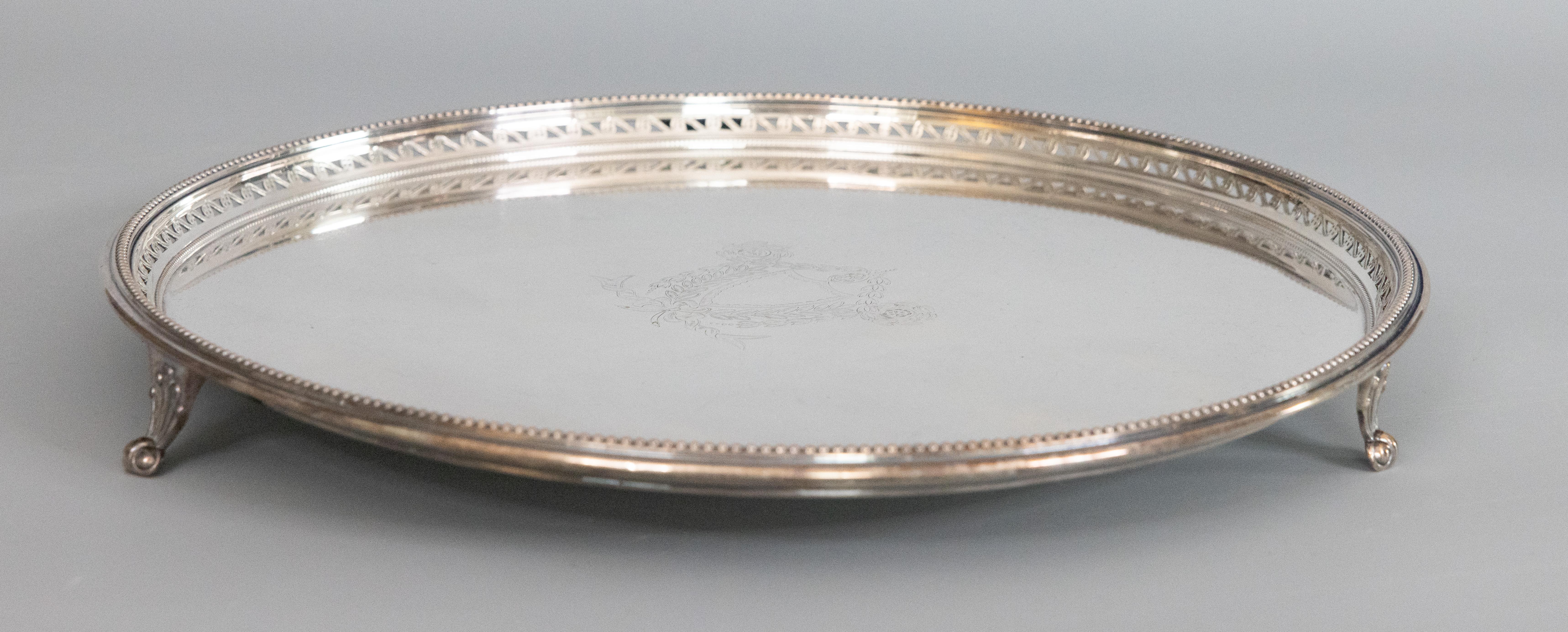 An antique English Edwardian silverplate footed salver or circular barware tray, circa 1900. Marked 