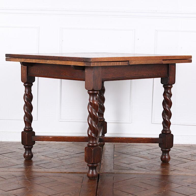 English Edwardian solid quarter-sawn oak draw-leaf table with barley twist legs and an ‘X’ stretcher. C. 1910

Dimensions listed below with leaves closed / tucked in. Fully-extended the table measures 60