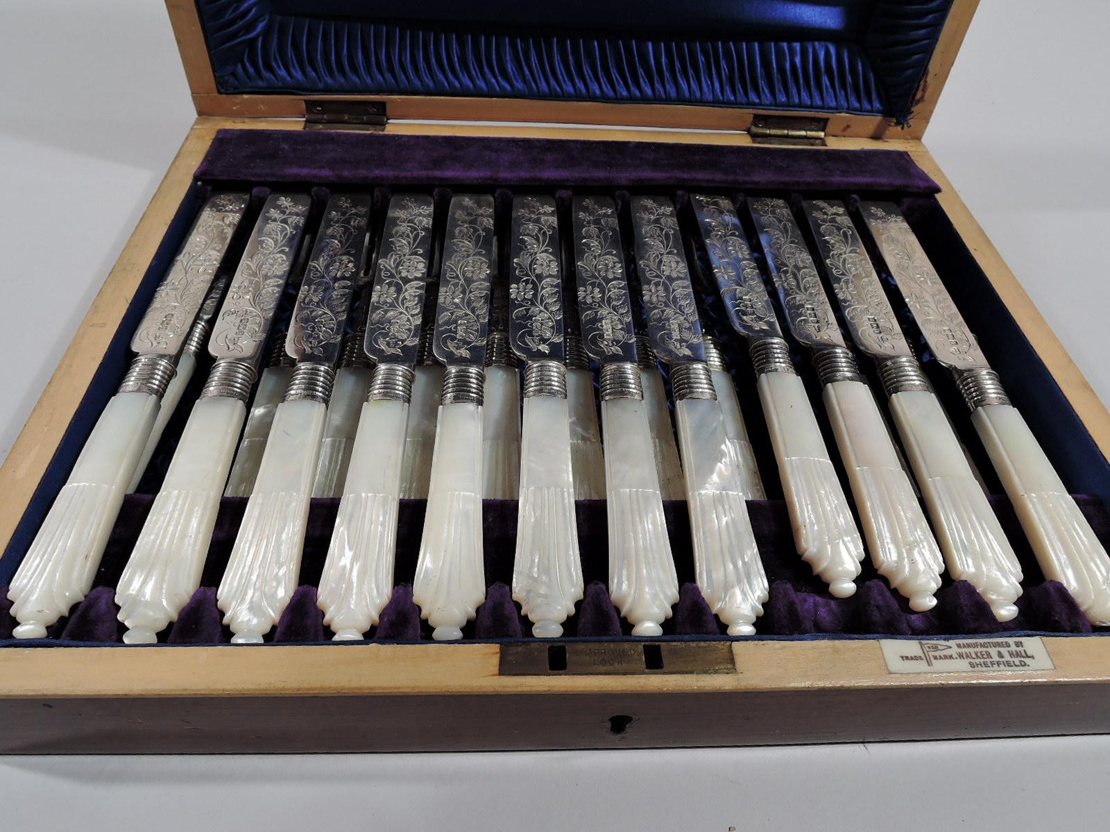 Edwardian sterling silver and mother of pearl fruit set. Made by Walker & Hall in Sheffield in 1902. This set comprises 12 knives and 12 forks.

Sterling silver blades and shanks engraved with flowers. Handles are mother of pearl with carved