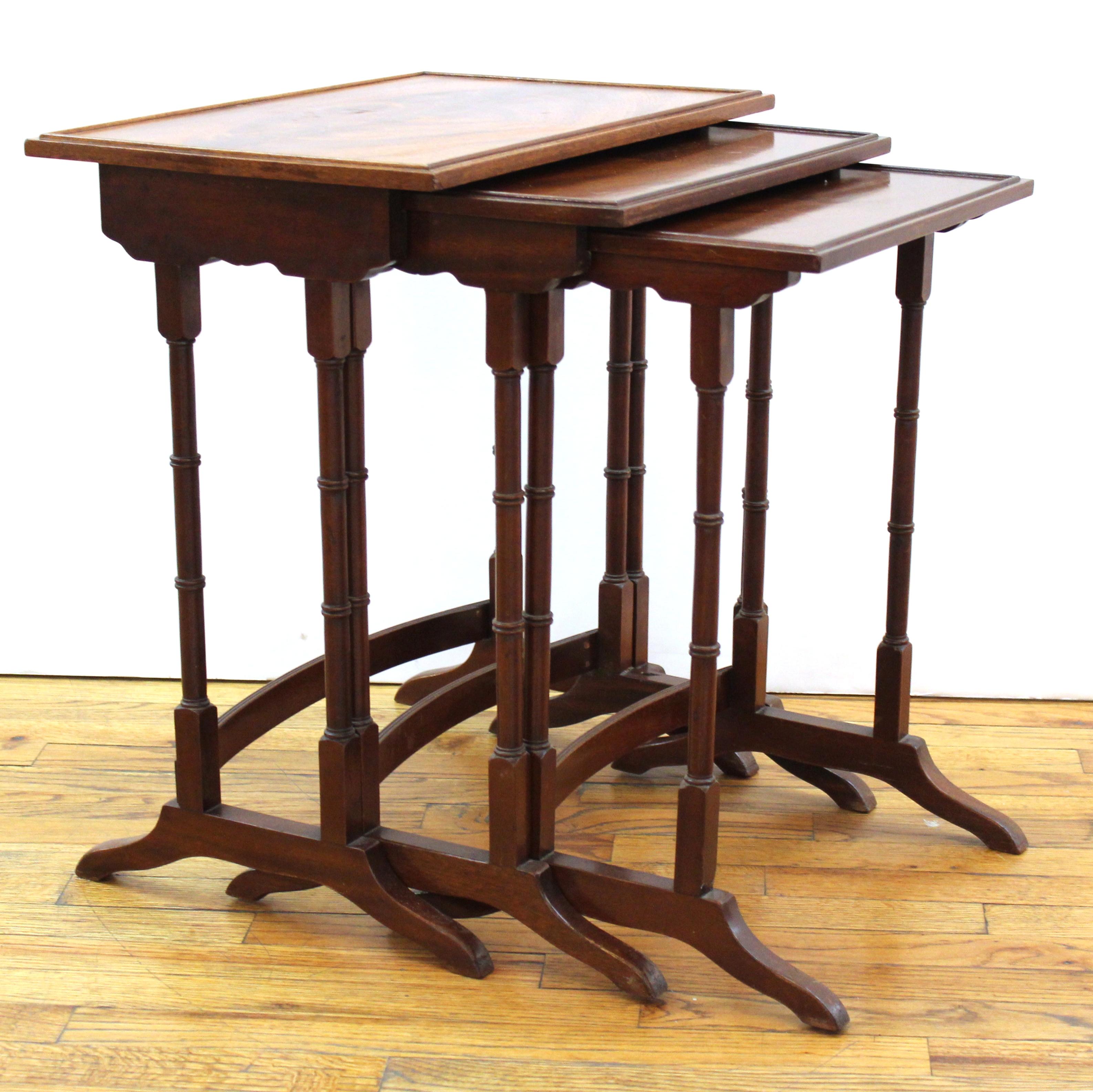 English Edwardian set of three nesting tables with curved cross stretchers.