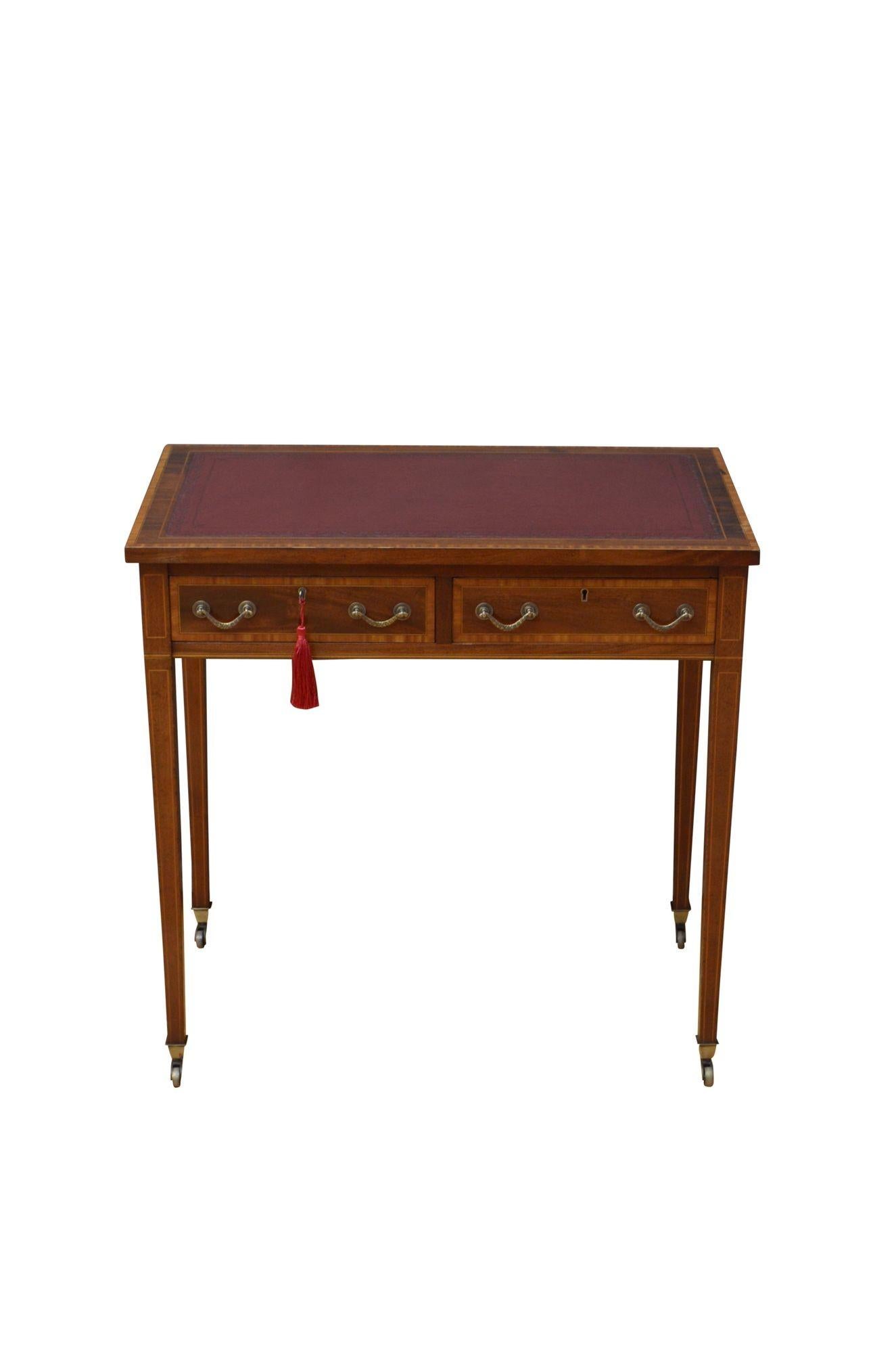 K0611 Fine quality English Edwardian writing desk of narrow proportions, having maroon leather writing surface, satinwood string inlaid and crossbanded top above two mahogany lined and crossbanded drawers fitted with brass swan neck handles,