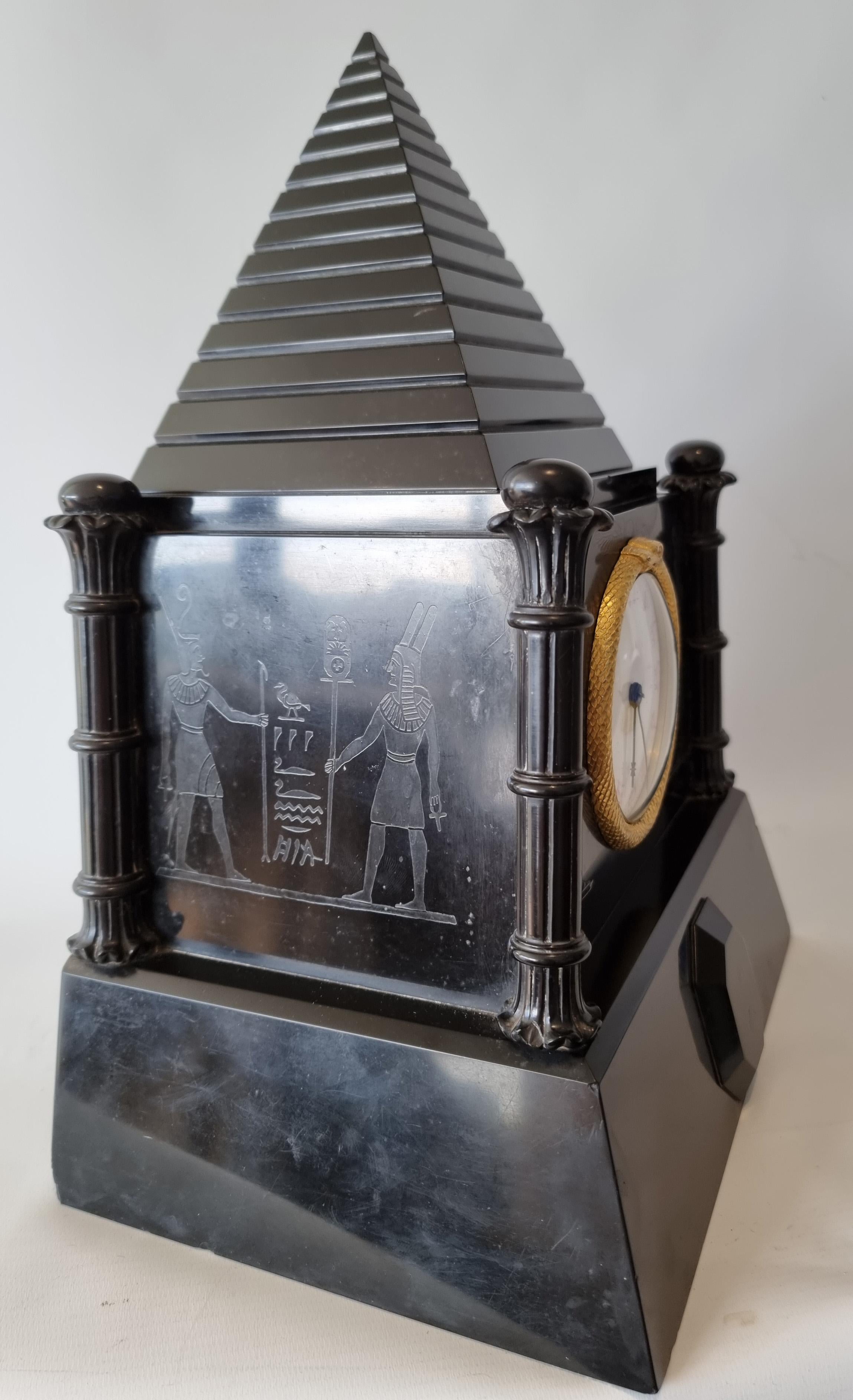 A fabulous and very rare antique English, Egyptian revival mantel clock with fusee movement by John Moore and Sons of London. This clock has a number of very unusual features. Constructed entirely of Derbyshire black marble it's shape is most