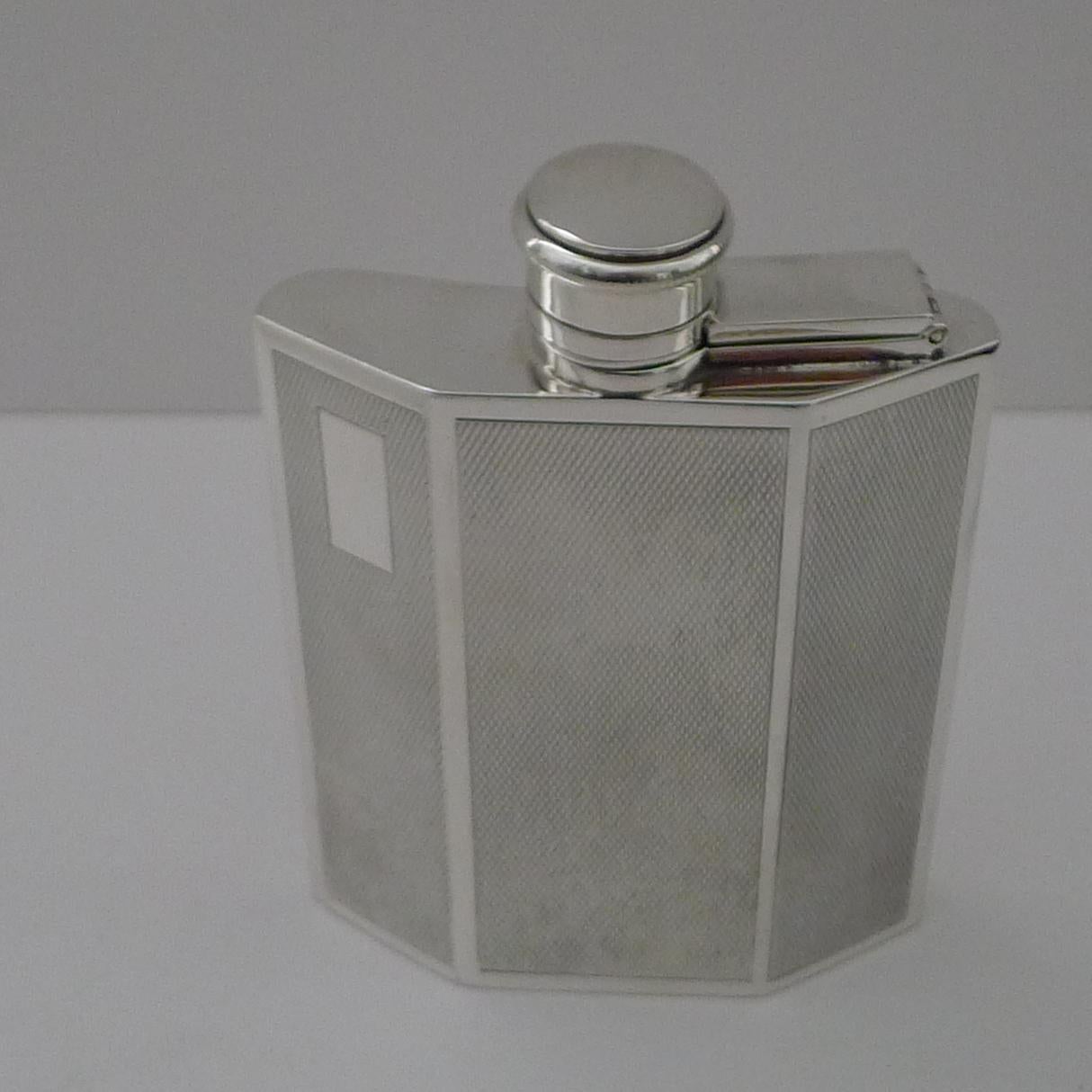 A striking vintage solid English / sterling silver spirit flask reminiscent of a traditional car radiator.

The flask is engine-turned decoration with a vacant cartouche to the left hand panel.  Shaped perfectly to fit in a pocket, the lid has a