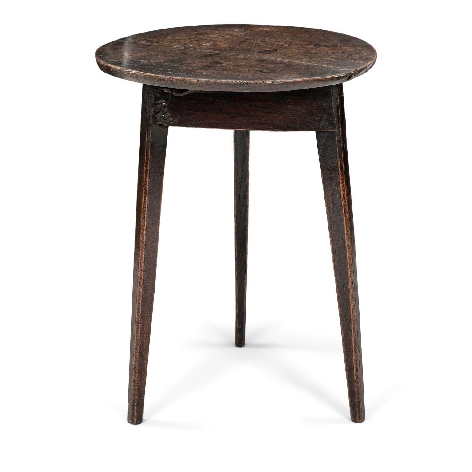 English elm cricket table circa 1780-1800. Dark brown elm and pine cricket with round top raised upon three tapered legs. Gorgeous mottled patina.