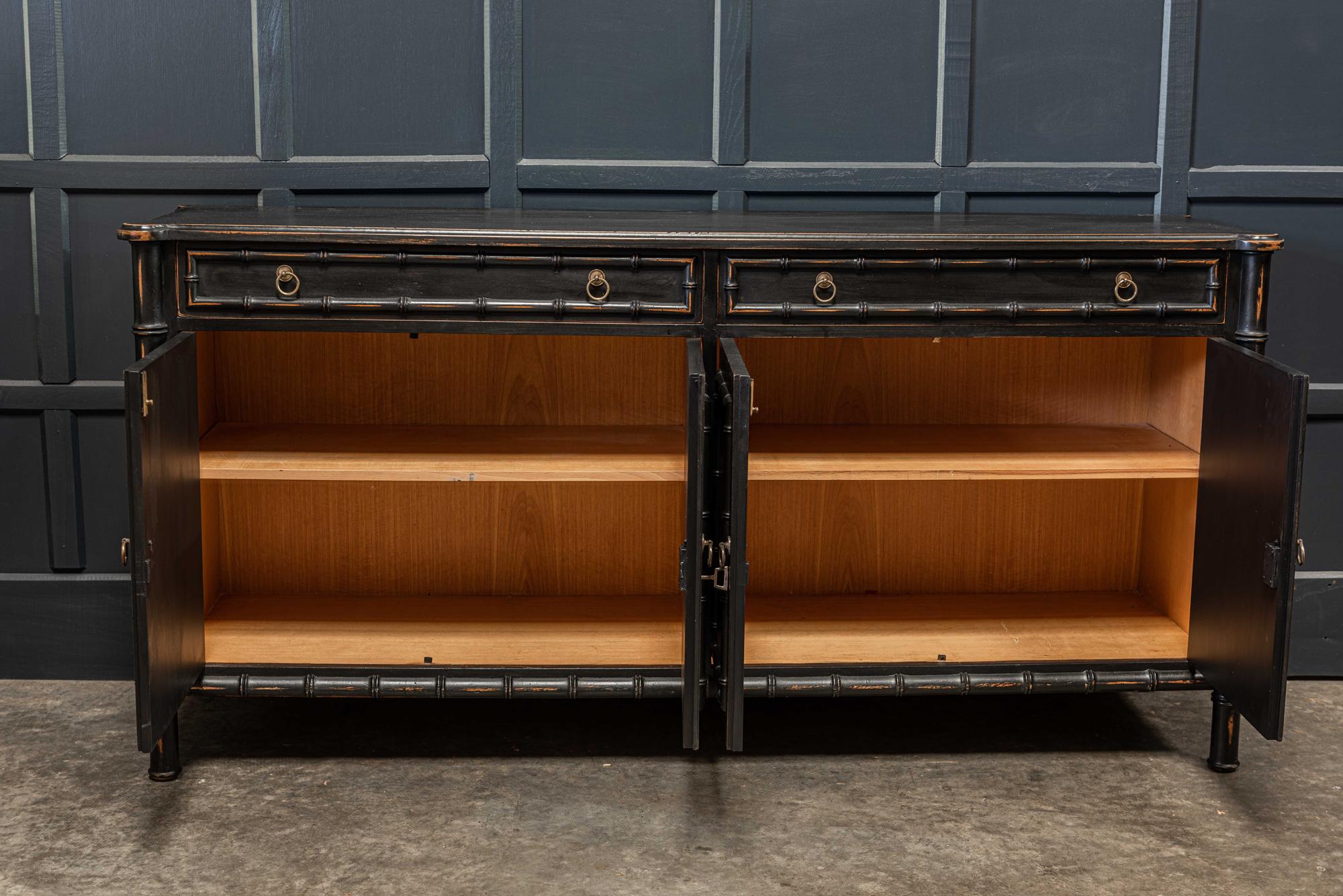 English Faux bamboo ebonized sideboard dresser/vanity,
circa 1950s.

Faux bamboo ebonized sideboard dresser/vanity.

Two dovetailed drawers above four doors with adjustable shelves and original brass hardware and locking key. Would make a great