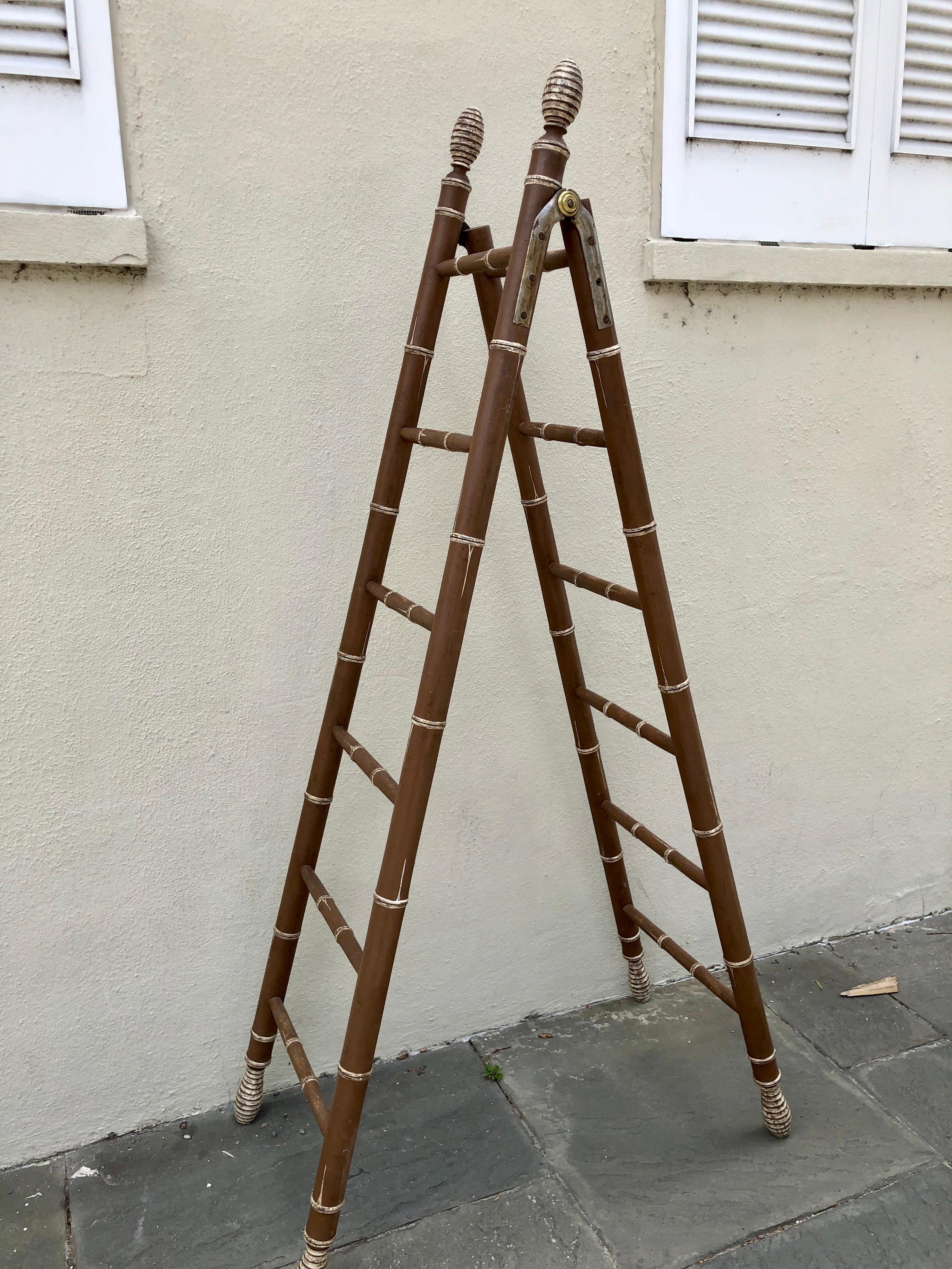 English faux bamboo library ladder in brown paint with white accents, circa 1830. Beehive turnings at top and bottom in white accents. Nickel silver and brass hinges.