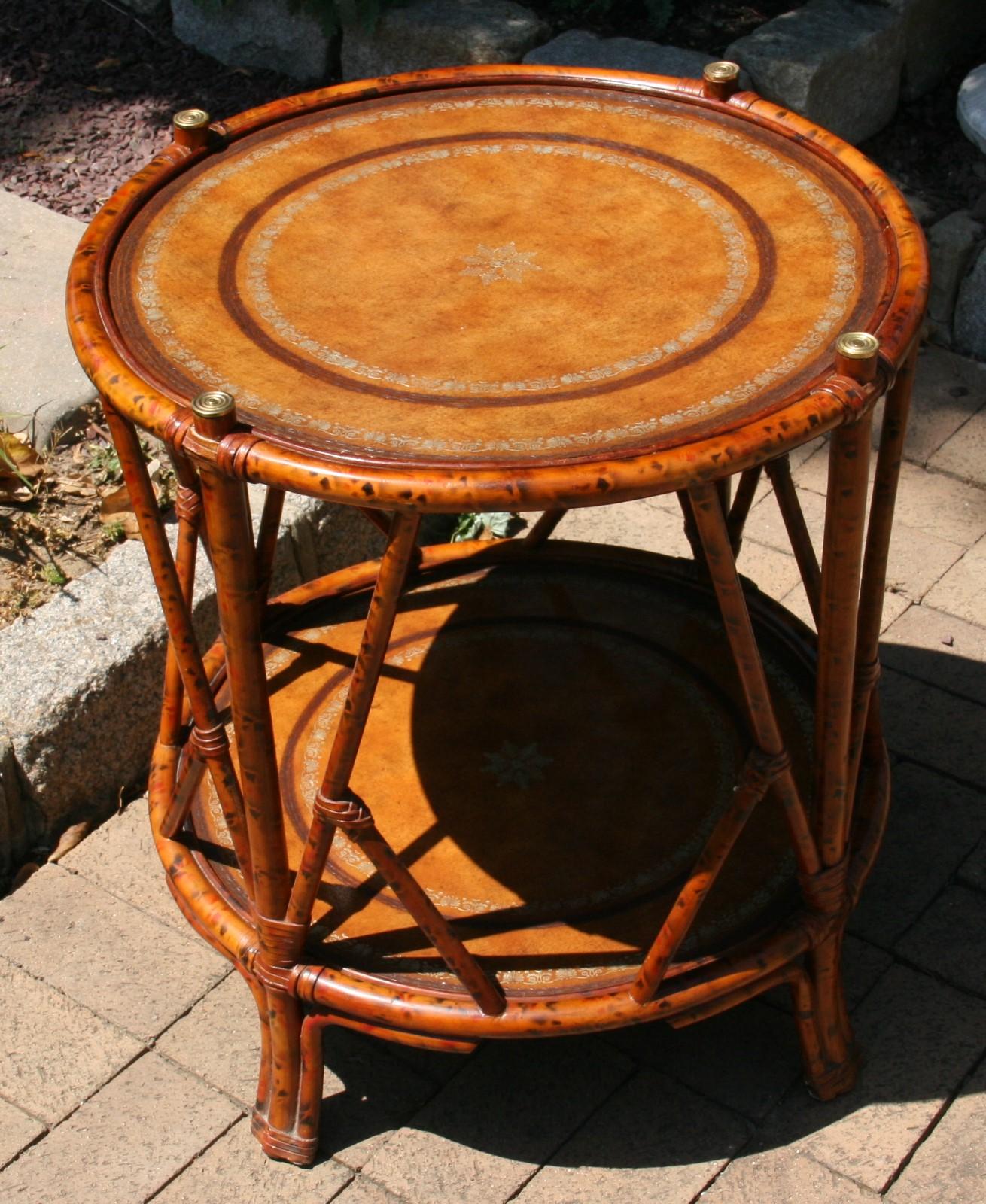3-563 English faux burnt bamboo two level round table with brass accents and leather top.
