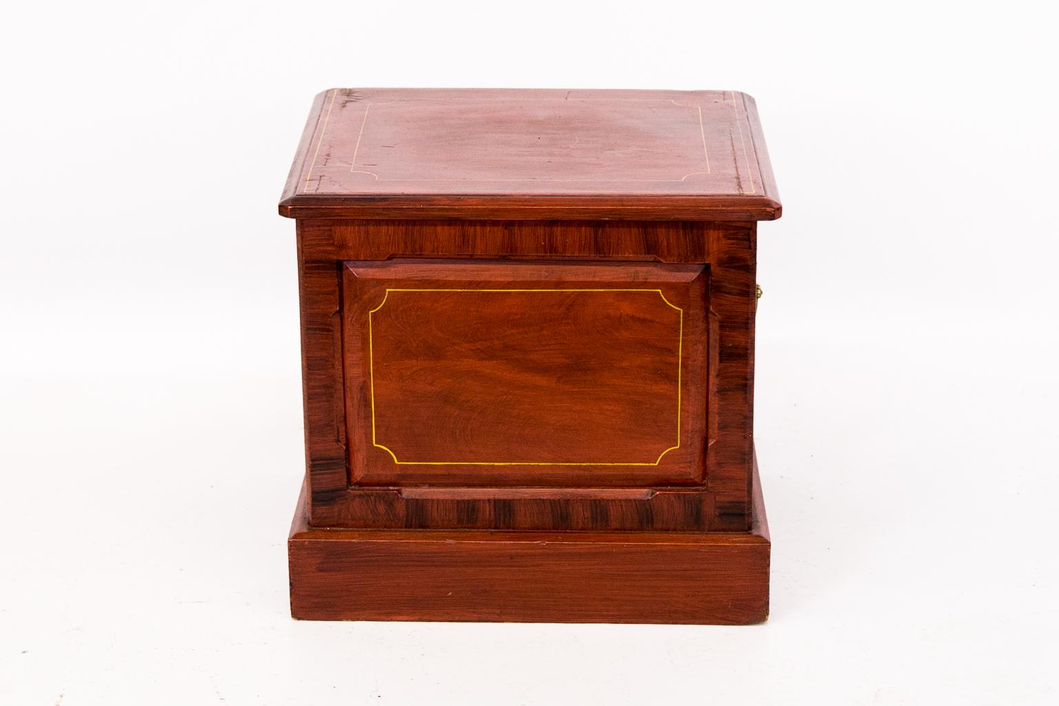 English faux painted commode, painted to simulate flame mahogany. The raised panel is framed by chamfered inside and outside edges. Which are faux painted to simulate rosewood crossbanding. The top is painted in similar fashion with line painting