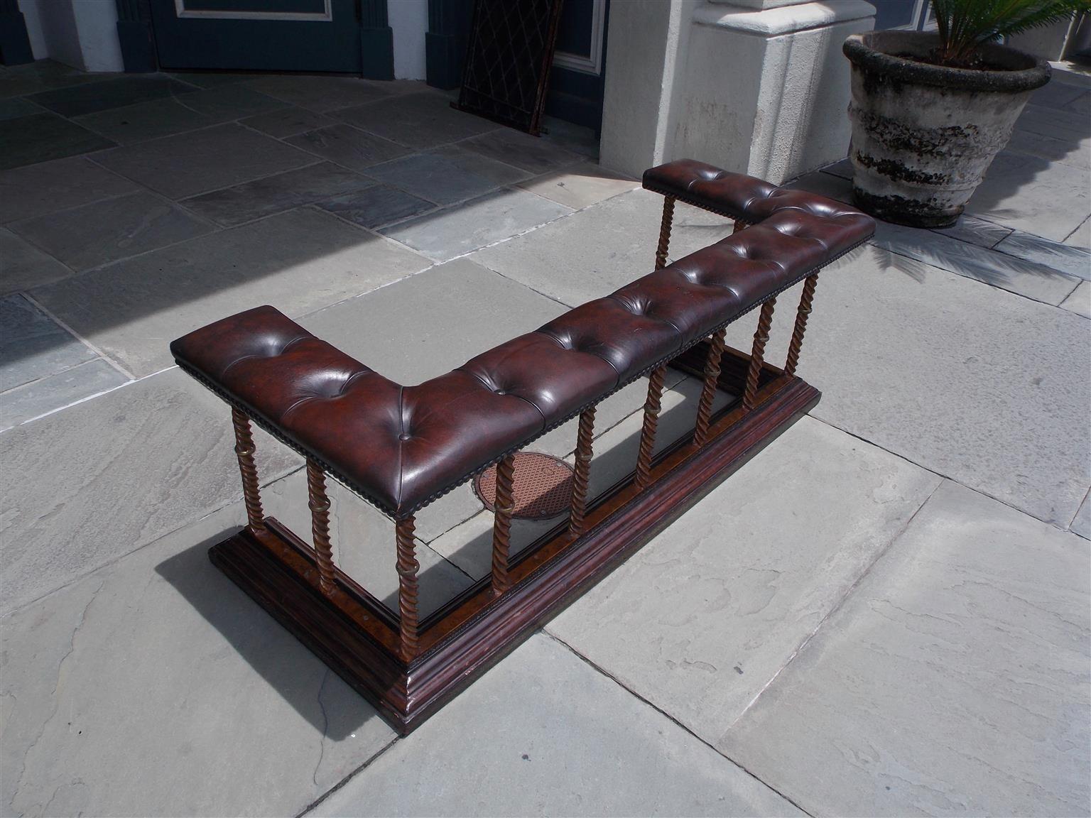 English faux painted burl walnut tufted brass tacked leather club fire place fender with a spiral column gallery, decorative cast brass rings, and terminating on step back carved molded edge base with stamped gilt tooling, Late 19th century.