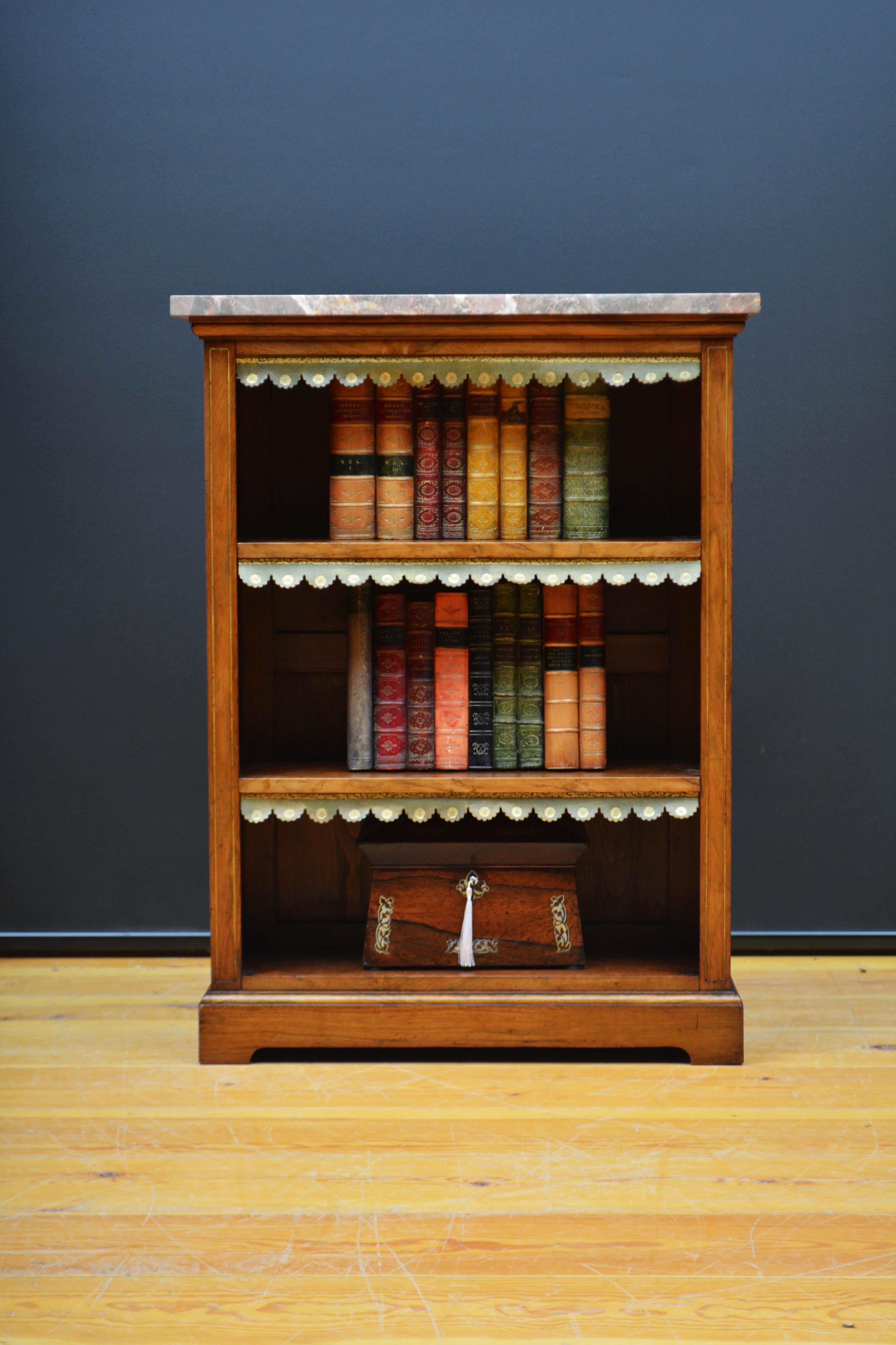 K0630 A low Victorian marble topped open  bookcase, having original veined marble above a shallow frieze and two height adjustable shelves all fitted with green tooled leather dust covers, flanked by fluted uprights with gilt decoration, all raised