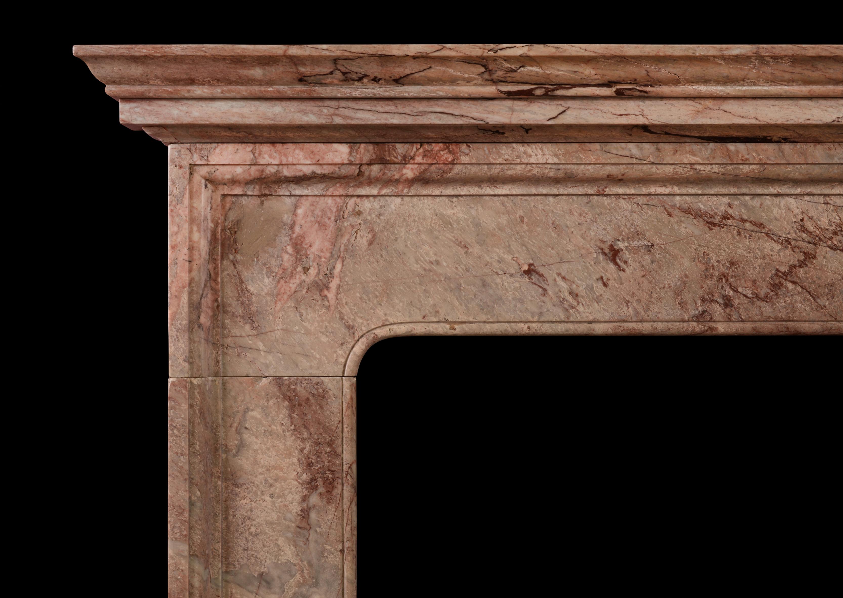An English moulded fireplace in Rose Vif des Pyreneese marble. The plain frieze and legs with moulded shelf above. The particularly narrow depth of this fireplace would make it well suited to a room where space is limited. 19th century, in the early