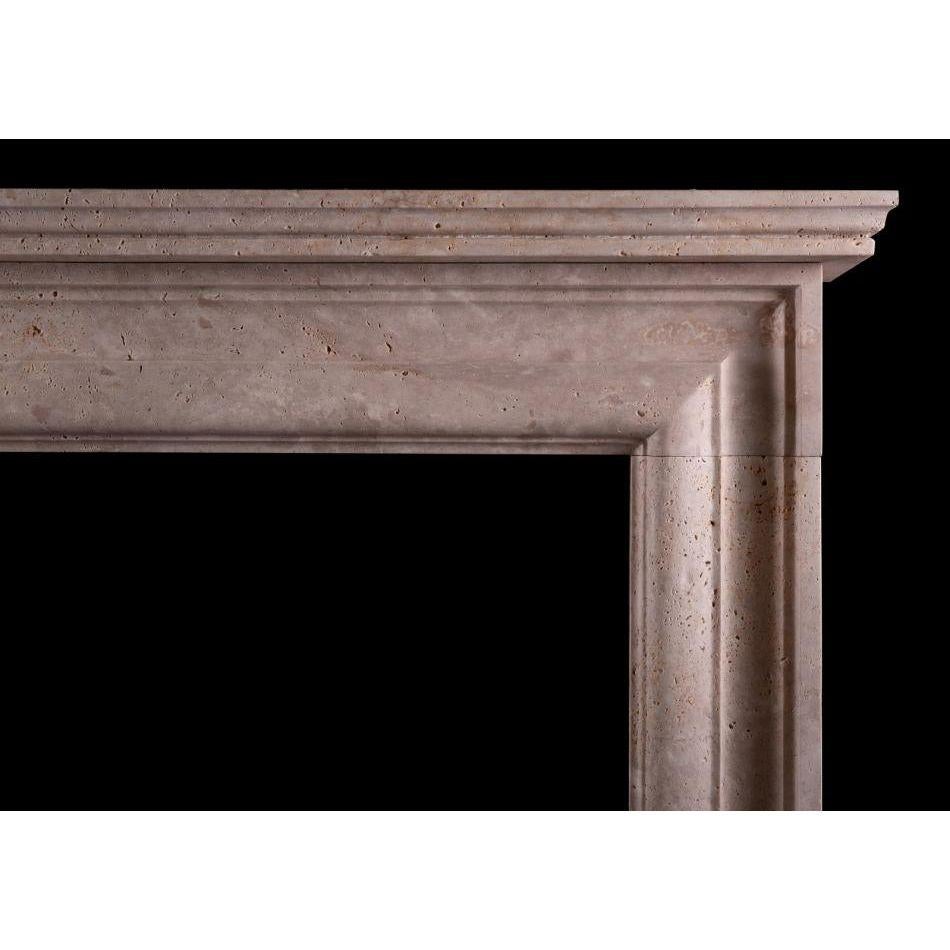 An English moulded bolection fireplace in Travertine stone. A scaled down version of a chimneypiece originally housed in the Officer's mess at Chelsea Barracks, London. Offered in three stock sizes, please search A008M-T and A008L-T for alternative