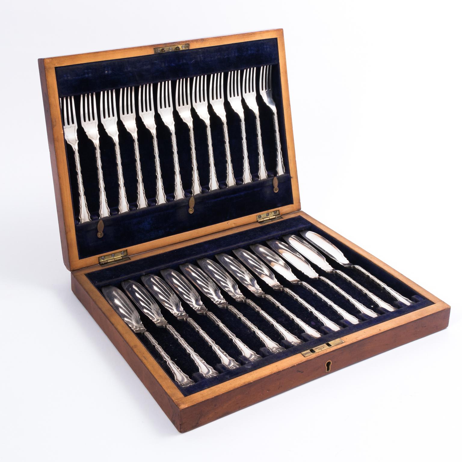 Vintage English fish set. Twelve forks-twelve marrow spoons-original oak case with key. All hallmarked twenty-four pieces. The box measures 2.50 inches height by 13.75 inches wide by 10.00 inches depth. The forks measure 6.50 inches height by 1.00