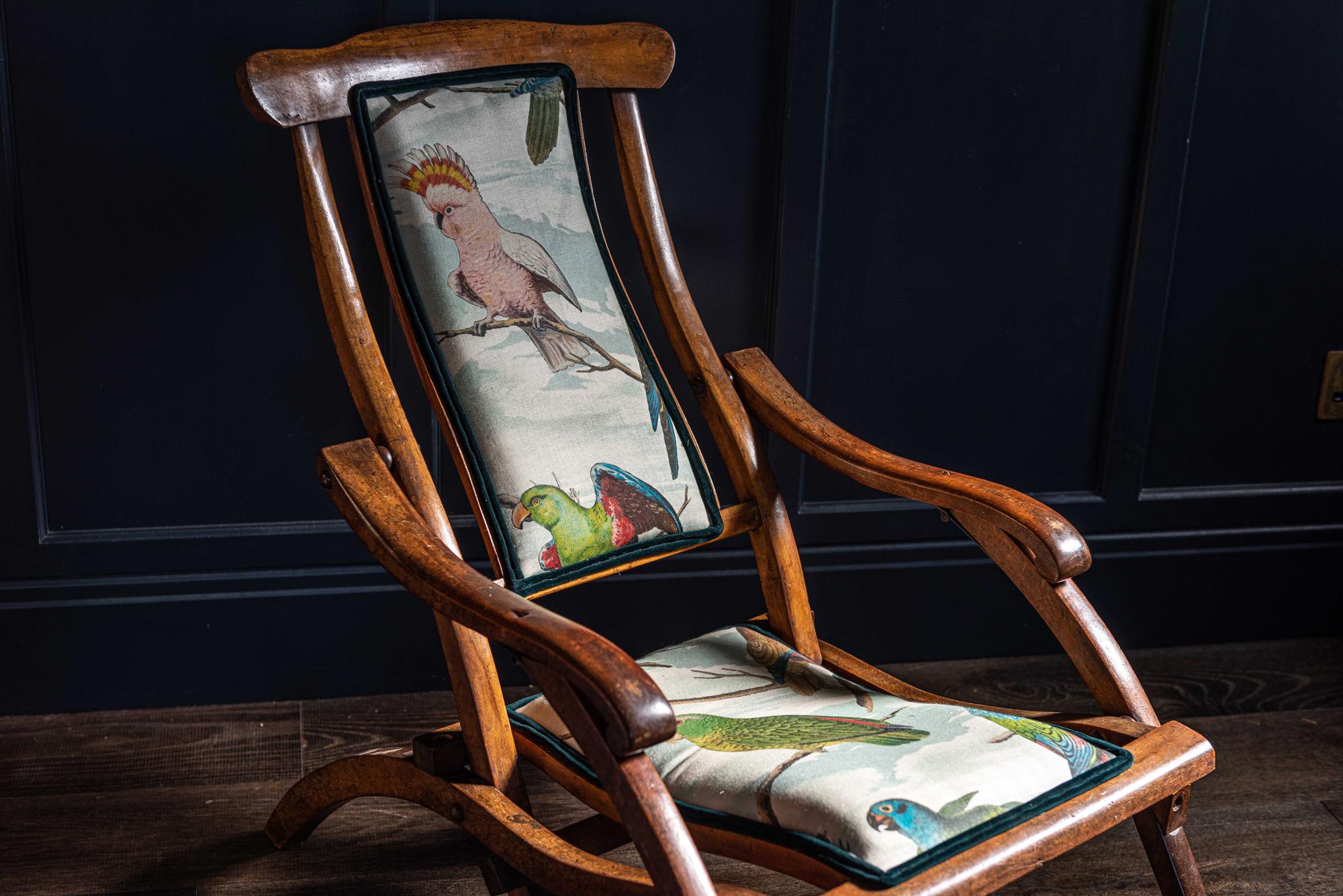 English folding mahogany steamer deck chair, late 19th century, circa 1890
Re-upholstered in 'Designers Guild' parrot aviary, sky blue linen

With scrolled arms, has a strong elegant and stylish design. The sloping back and seat, shaped to give a