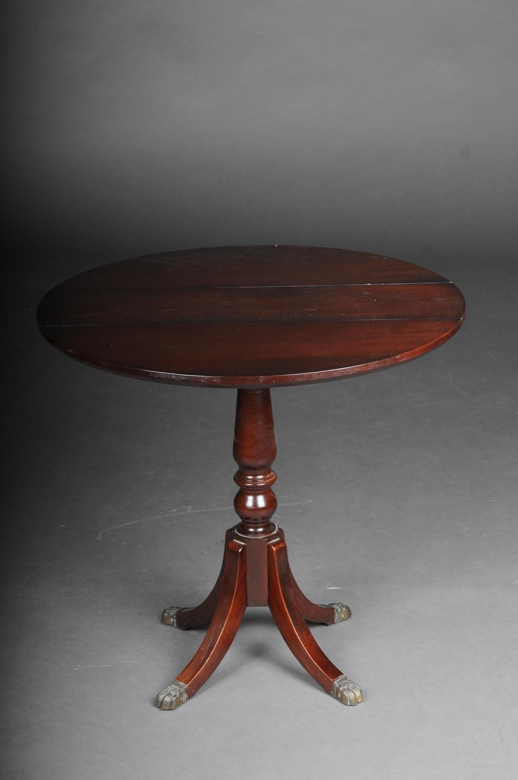 English folding table / side table / table, 20th century

Solid wood stained with mahogany. English side table, 20th century, Victorian style. Round cover plate. Pages can be opened. Round cover plate on profiled balustrade shaft ending on four