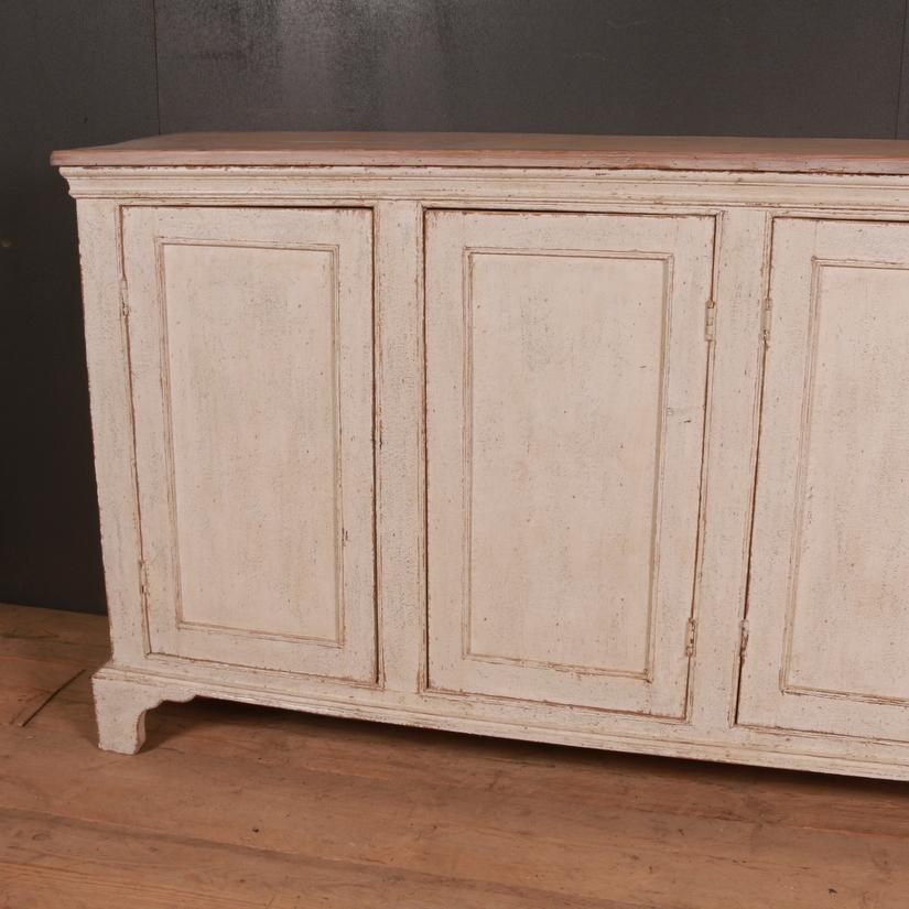 Narrow 19th century English painted four door buffet with a shelved interior, 1840.

Dimensions:
74.5 inches (189 cms) wide
18.5 inches (47 cms) deep
37 inches (94 cms) high.

We will add either locks or brass turn handles to this item upon