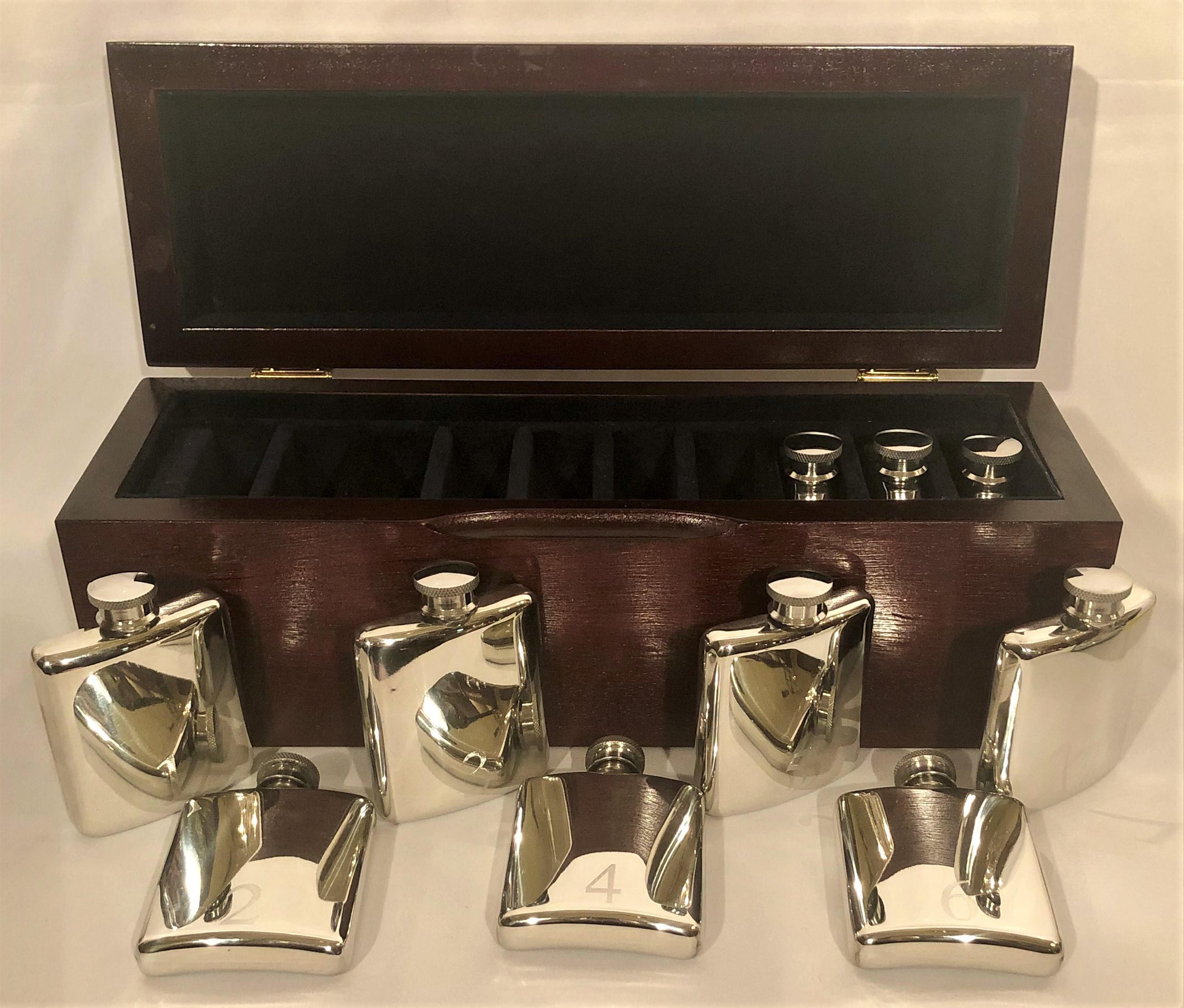 There are 10 silver flasks, number 1-10, in this fitted box. The flasks were numbered so that the members of the hunt would know which flasks was theirs.