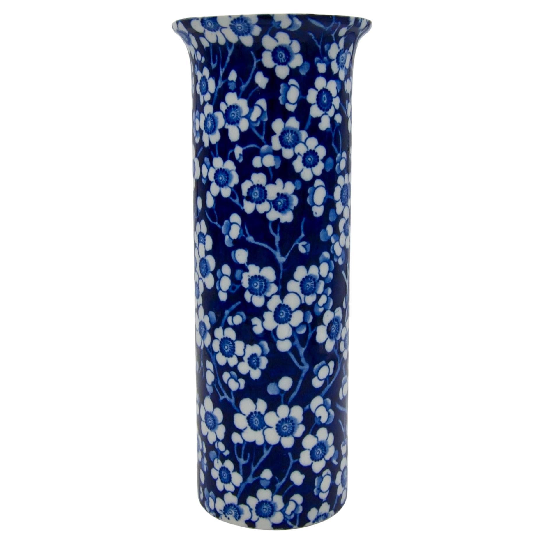 An early 20th century English Prunus vase in earthenware designed by Frederick Rhead for Wood & Sons of England, circa 1910s. Rhead's blue and white version of the Chinese Prunus pattern features a transfer-printed design of white flower blossoms