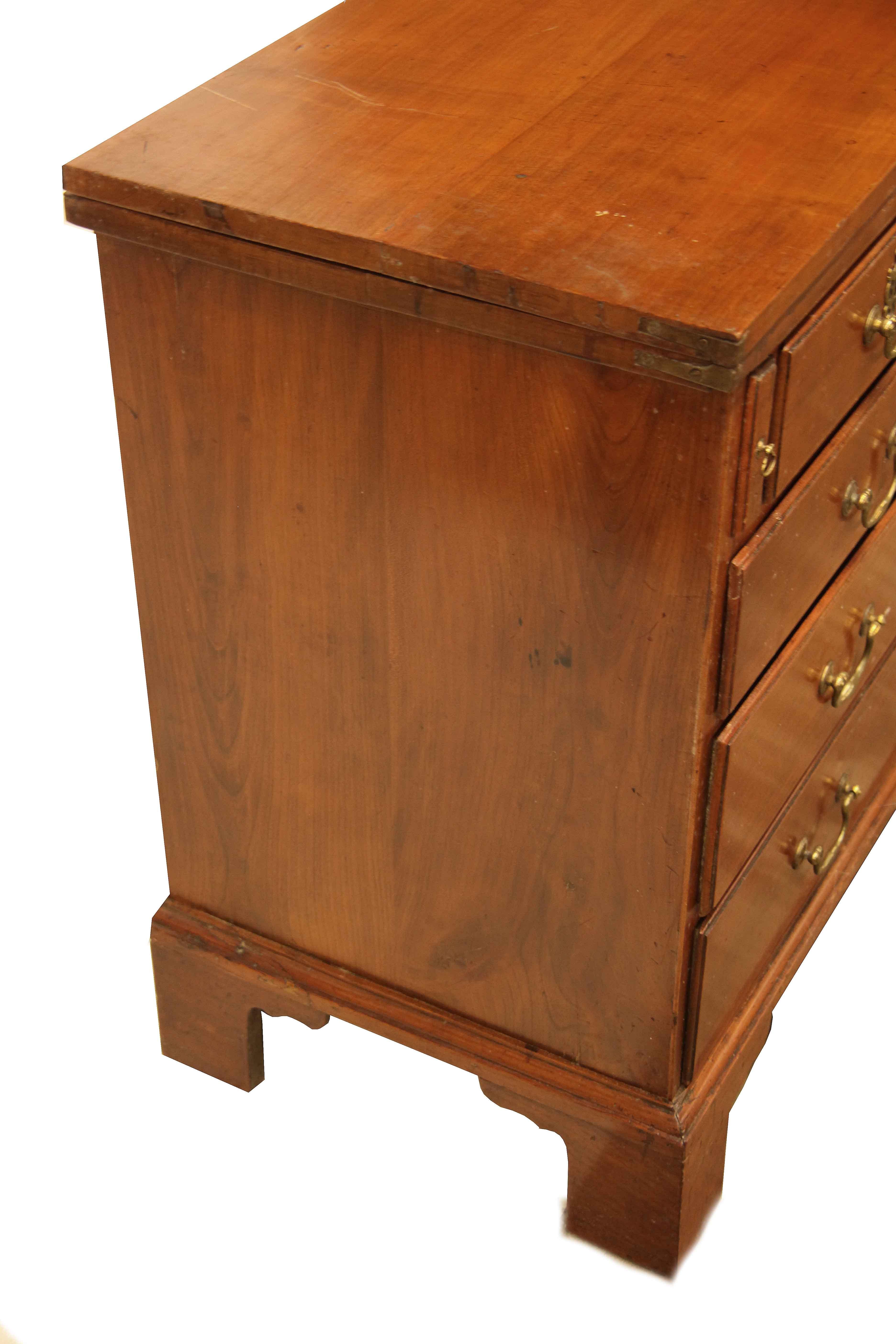 English fruit wood fold over top chest, this chest features an extra top that folds over from the front, supported by the pull-out slides. The two over three graduated drawers have an overlapping half round molding, pine is secondary wood; the swan