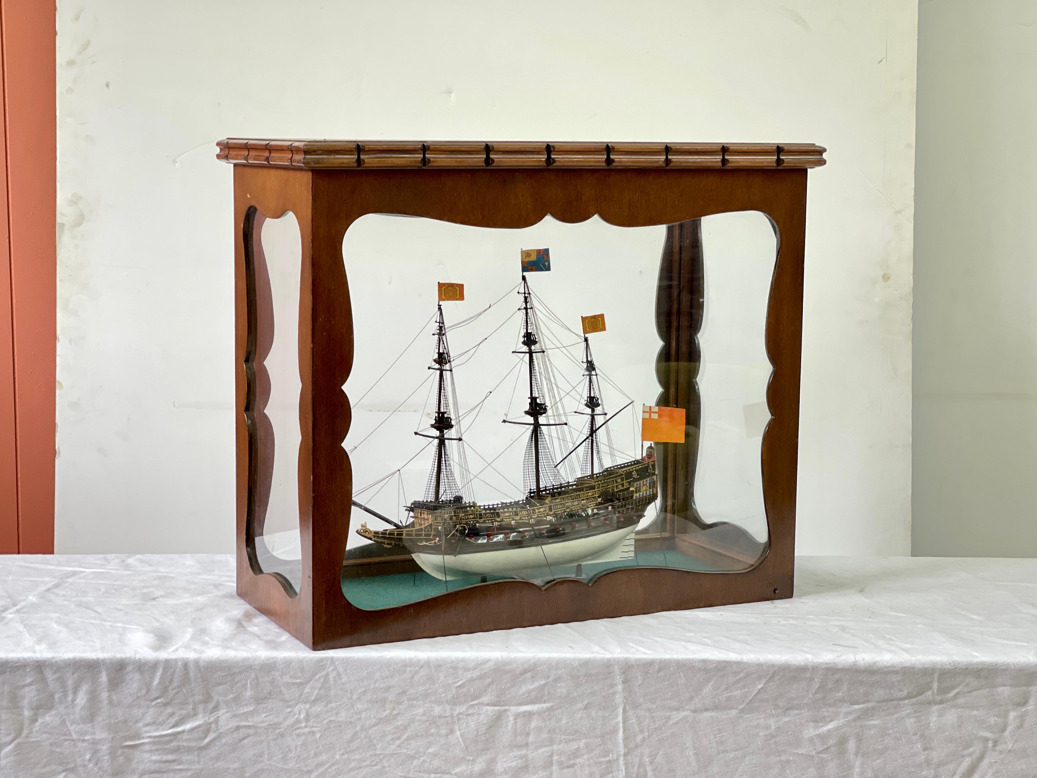 20th Century English ship model of the HMS Revenge, an English galleon built by Sir John Hawkins in the shipyards of Deptford in 1577. The sailing warship model is enclosed by a custom glass and mahogany showcase.