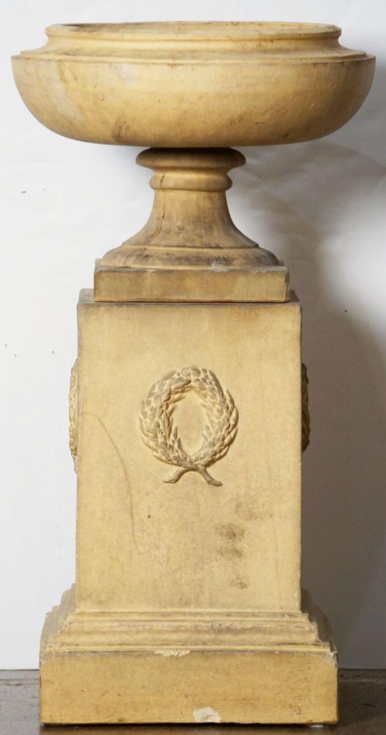 A fine English garden urn or planter pot on stand of buff terracotta in the Classical style, from the 19th century, stamped Doulton and Co. Ltd - Lambeth.

Note: Circumference of Urn is 17 1/2 inches