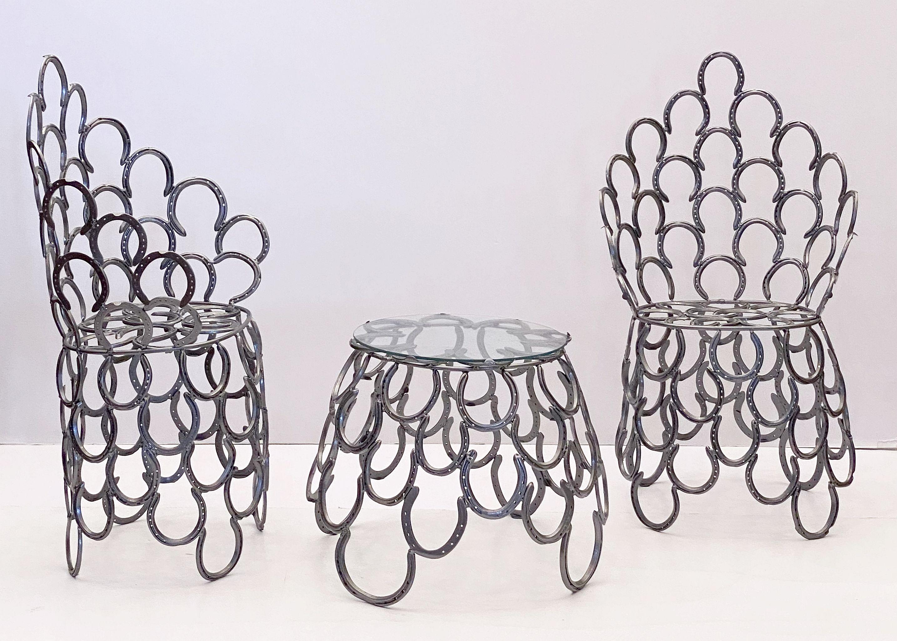 A lovely English garden set (includes table and two chairs) - each piece featuring a decorative design of iron horseshoes that together create a very comfortable seating. The table includes an optional fitted round glass top

Table dimensions: