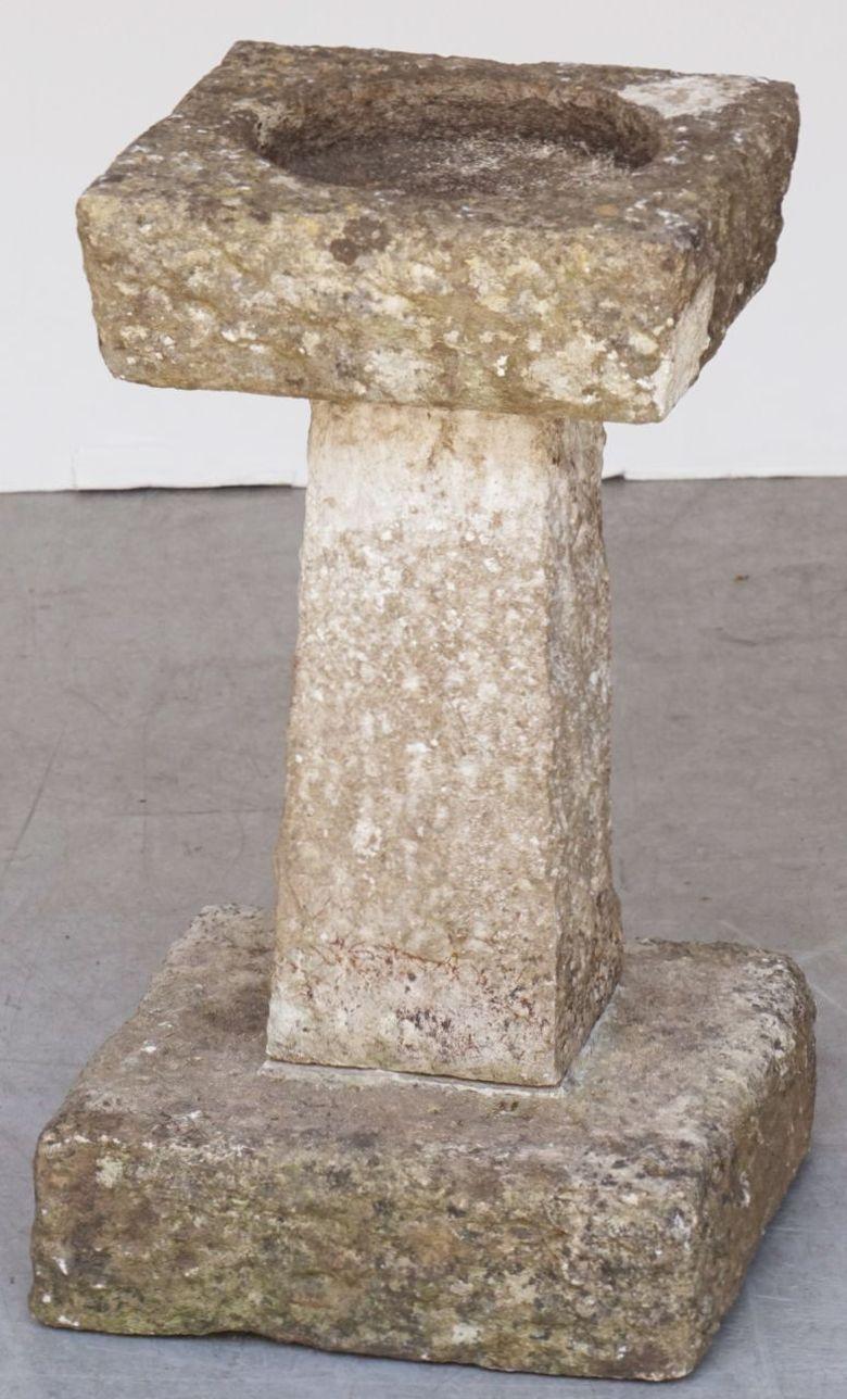 A fine English garden bird bath of cut and chiseled Purbeck stone, from the late 19th century, featuring a square top with round recessed bath area in the center, set upon a four-sided tapering pedestal with square plinth base. 

Purbeck stone