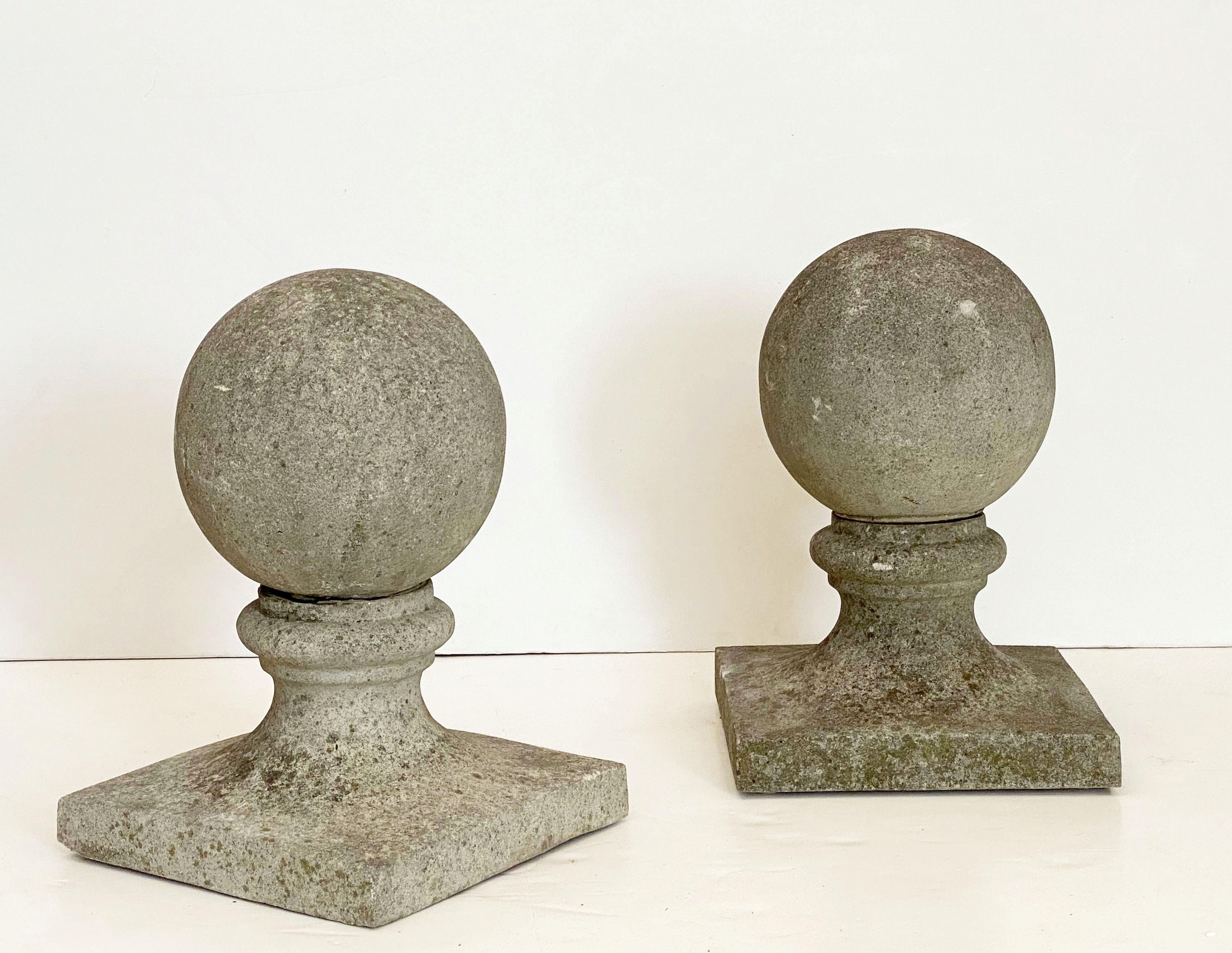 A fine pair of English coping balls of composition stone, each ball set upon a square plinth base.

Dimensions are H 21 1/2 inches x D 14 1/2 inches

Perfect for use as an indoor or outdoor garden, garden room, or patio feature!

Individually